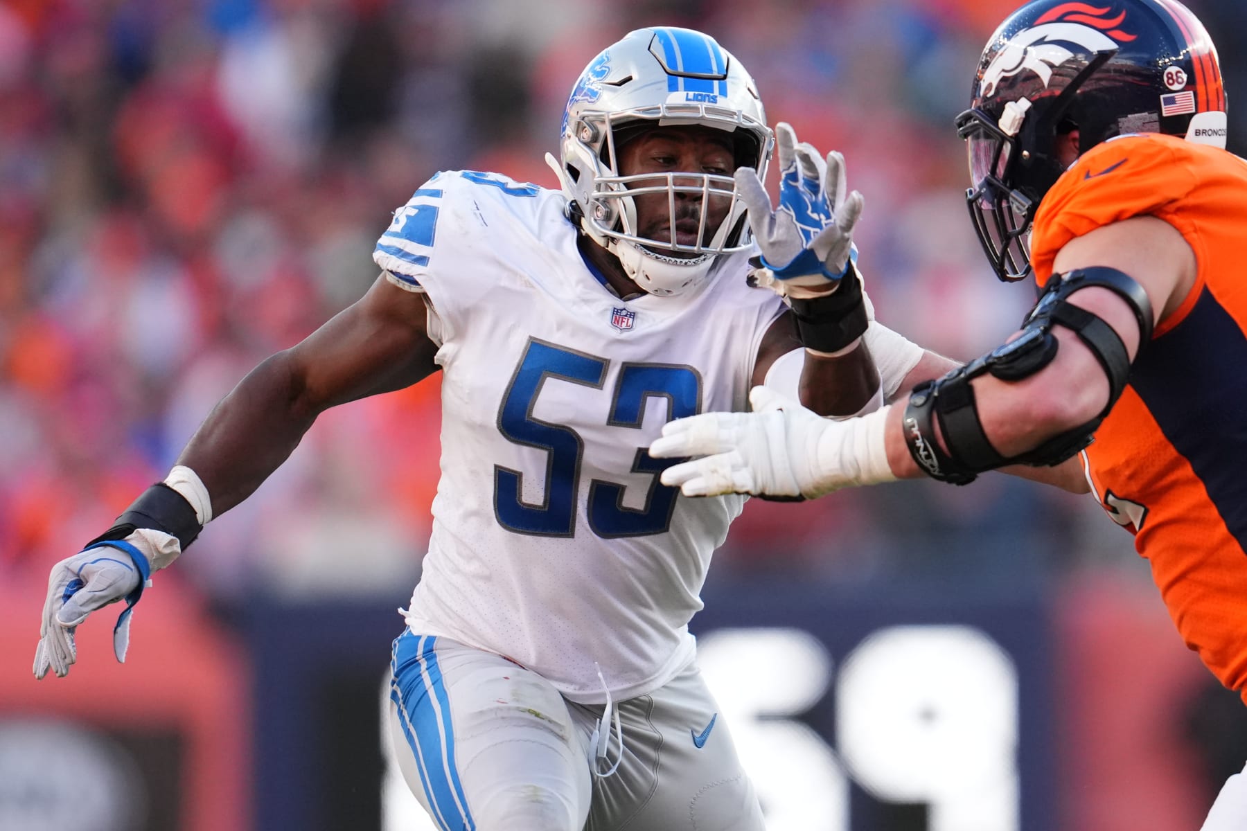 DENVER, COLORADO - DECEMBER 12: Charles Harris #53 of the Detroit Lions defends against the Denver Broncos during an NFL game at Empower Field At Mile High on December 12, 2021 in Denver, Colorado. (Photo by Cooper Neill/Getty Images)