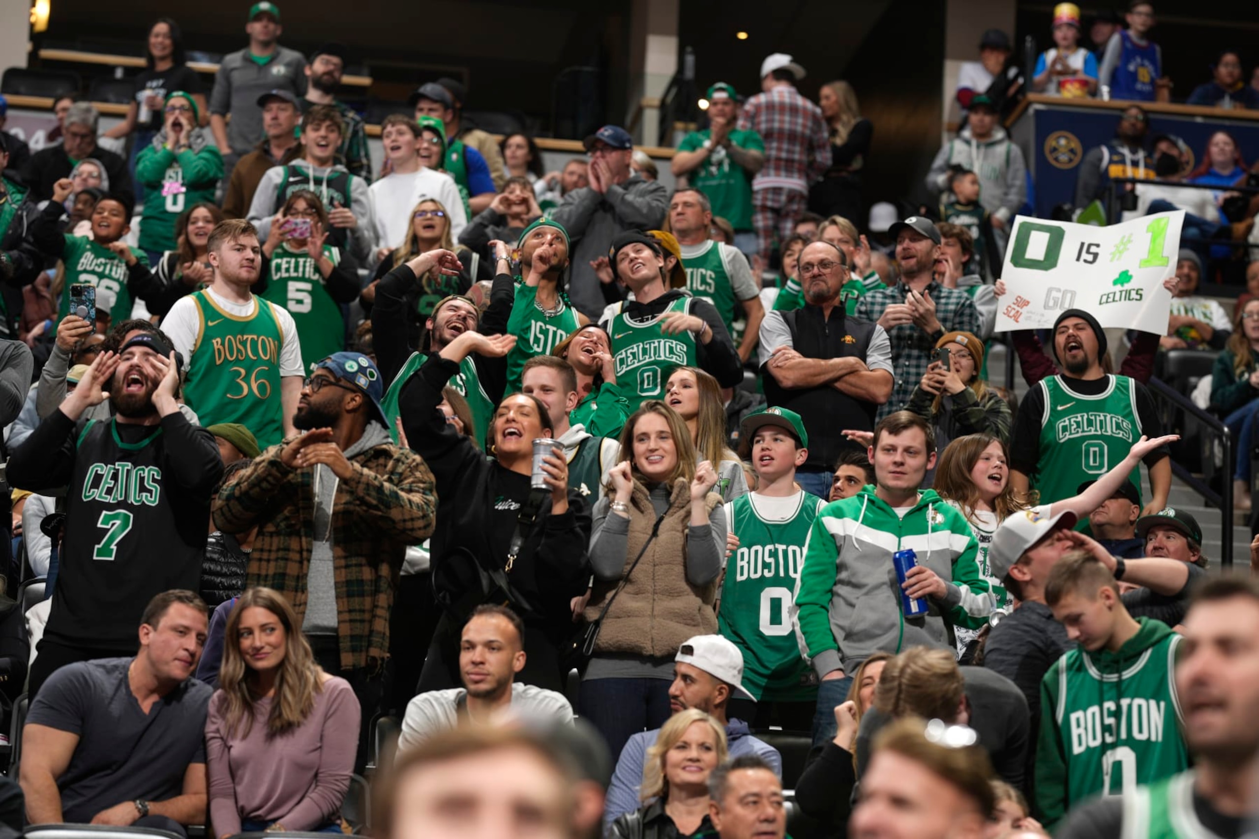Boston Celtics fans cheer in the second half of an NBA basketball game against the Denver Nuggets, Sunday, Jan. 1, 2023, in Denver. (AP Photo/David Zalubowski) Boston Celtics fans cheer in the second half of an NBA basketball game against the Denver Nuggets, Sunday, Jan. 1, 2023, in Denver. (AP Photo/David Zalubowski)