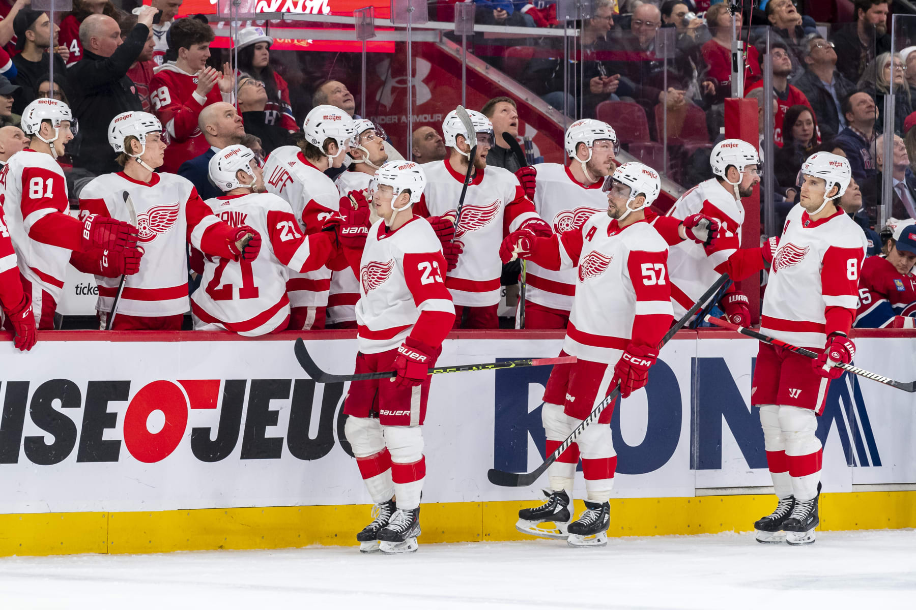 MONTREAL, CANADA - APRIL 4: Lucas Raymond #23 of the Detroit Red Wings celebrates a goal with the bench during the first period of the NHL regular season game between the Montreal Canadiens and the Detroit Red Wings at the Bell Centre on April 4, 2023 in Montreal, Quebec, Canada. (Photo by Francois Lacasse/NHLI via Getty Images)