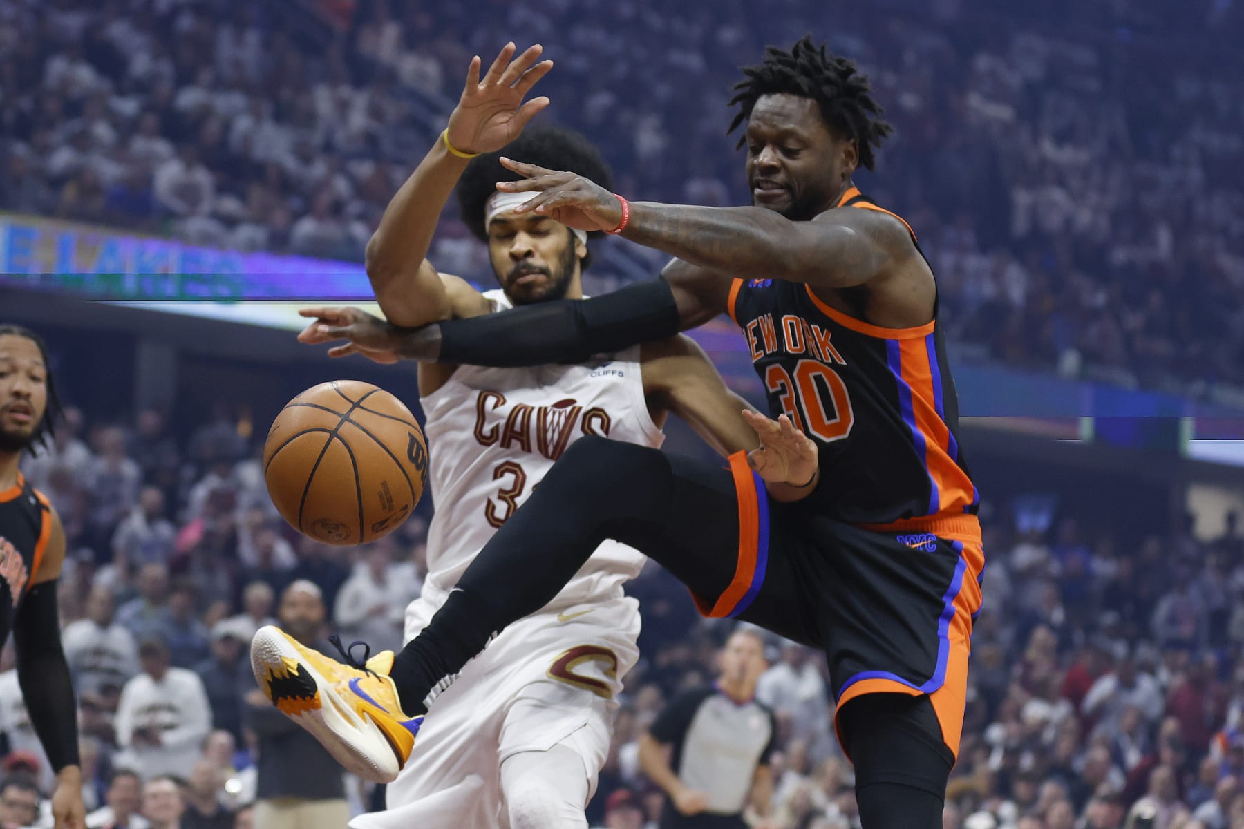New York Knicks forward Julius Randle (30) and Cleveland Cavaliers center Jarrett Allen go for a rebound during the first half of Game 2 of an NBA basketball first-round playoff series Tuesday, April 18, 2023, in Cleveland. (AP Photo/Ron Schwane)