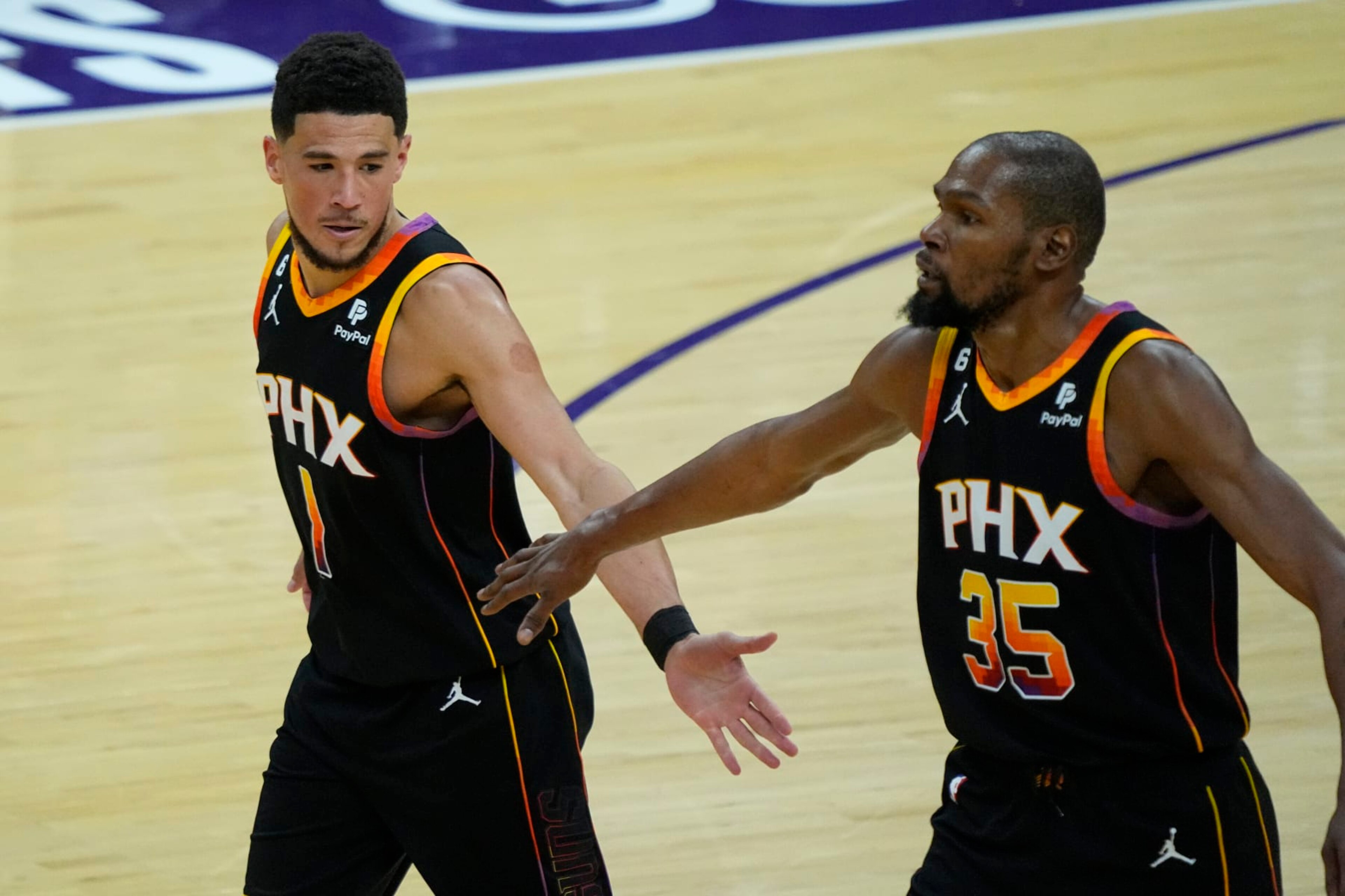 Phoenix Suns guard Devin Booker (1) and forward Kevin Durant (35) celebrate a basket against the Los Angeles Clippers during the second half of Game 1 of a first-round NBA basketball playoff series, Sunday, April 16, 2023, in Phoenix. (AP Photo/Matt York) Phoenix Suns guard Devin Booker (1) and forward Kevin Durant (35) celebrate a basket against the Los Angeles Clippers during the second half of Game 1 of a first-round NBA basketball playoff series, Sunday, April 16, 2023, in Phoenix. (AP Photo/Matt York)