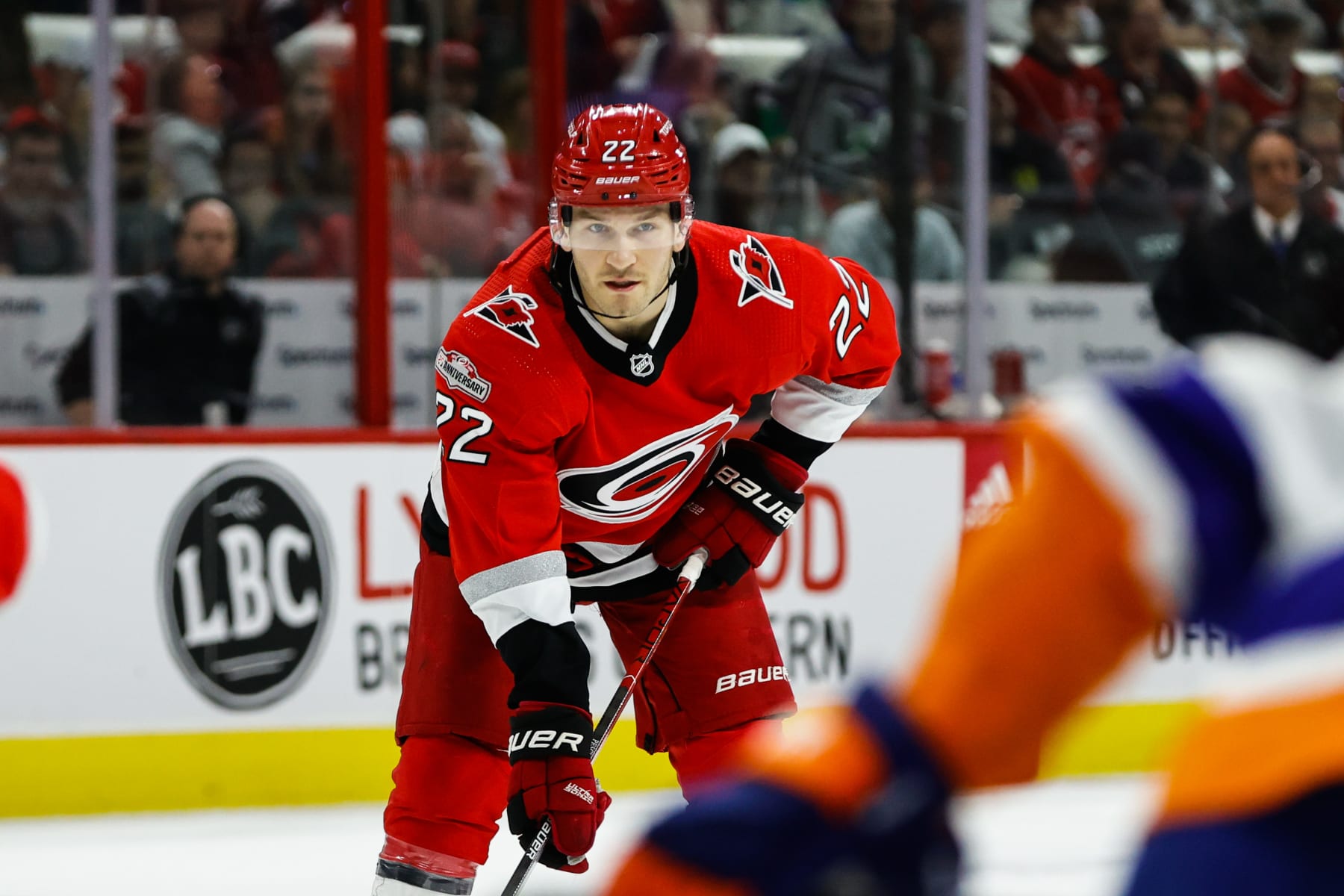 RALEIGH, NC - APRIL 17: Brett Pesce #22 of the Carolina Hurricanes look onto the face off against New York Islanders during the second period of Eastern Conference Game One of the First Round of the 2023 Stanley Cup Playoffs at PNC Arena on April 17, 2023 in Raleigh, North Carolina. Hurricanes defeat Islanders 2-1. (Photo by Jaylynn Nash/Getty Images)