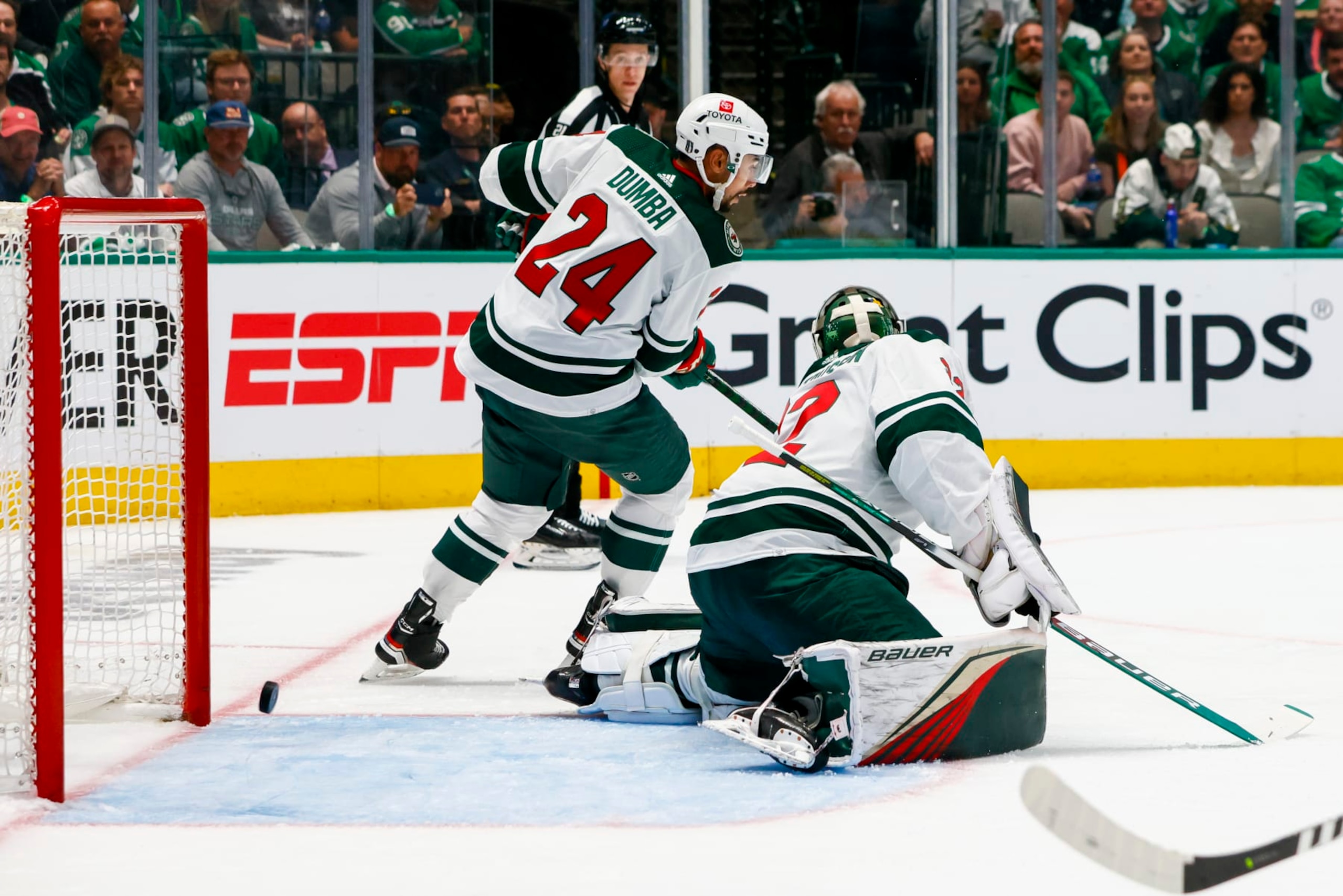 DALLAS, TX - APRIL 17: Minnesota Wild defenseman Matt Dumba (24) and goaltender Filip Gustavsson (32) miss the puck as it hits the posts during the game between the Dallas Stars and the Minnesota Wild on April 17, 2023 at American Airlines Center in Dallas, Texas. (Photo by Matthew Pearce/Icon Sportswire via Getty Images)