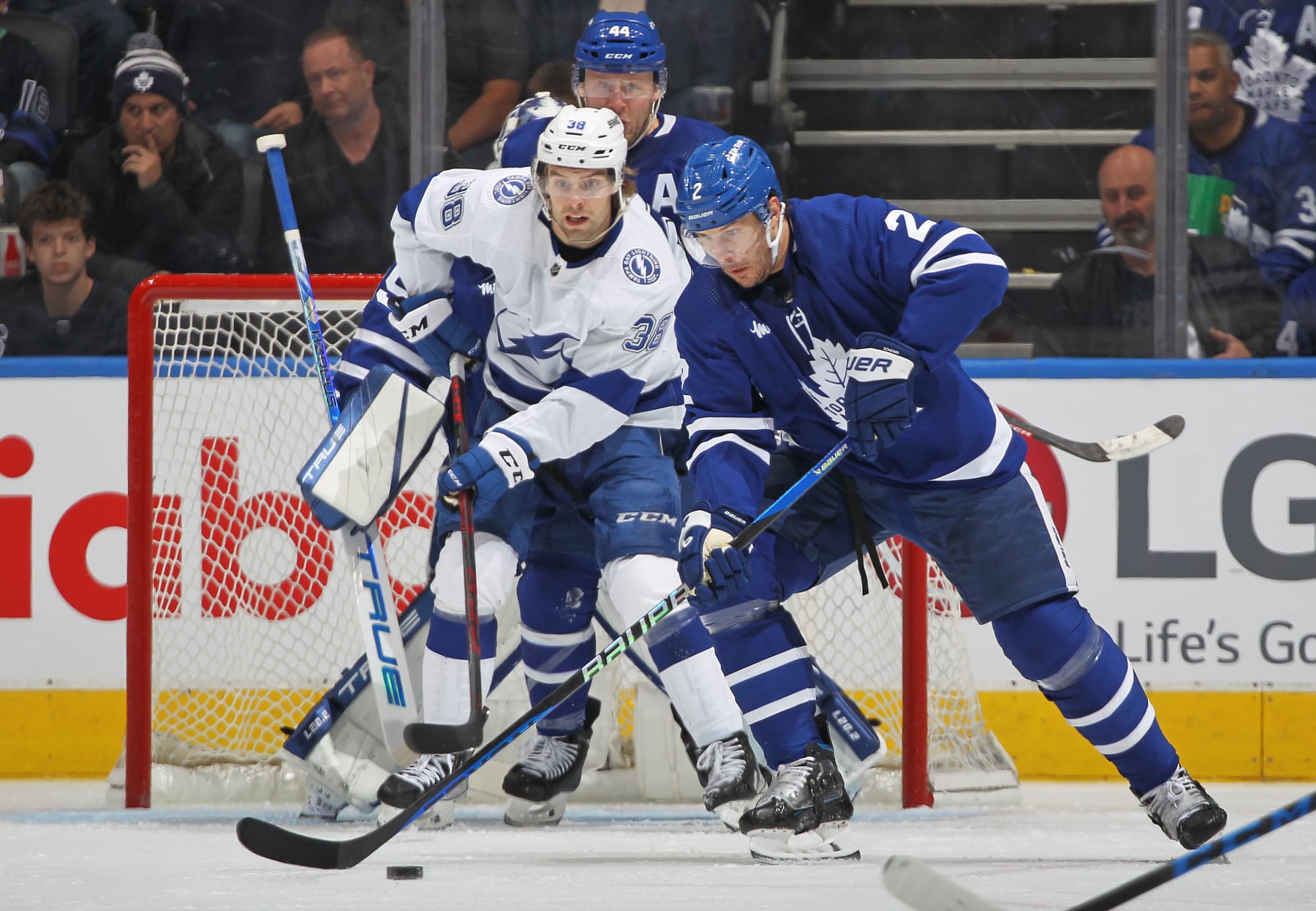 TORONTO, CANADA - APRIL 18:  Luke Schenn #2 of the Toronto Maple Leafs clears puck away from Brandon Hagel #38 of the Tampa Bay Lightning during Game One of the First Round of the 2023 Stanley Cup Playoffs at Scotiabank Arena on April 18, 2023 in Toronto, Ontario, Canada. The Lightning defeated the Maple Leafs 7-3. (Photo by Claus Andersen/Getty Images)