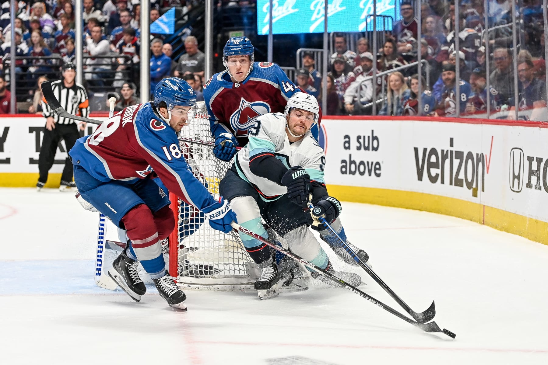 DENVER, COLORADO - APRIL 18:  Ryan Donato #9 of the Seattle Kraken draws a holding penalty as he skates against Alex Newhook #18 and Josh Manson #42 of the Colorado Avalanche in the first period of Game One in the First Round of the 2023 Stanley Cup Playoffs at Ball Arena on April 18, 2023 in Denver, Colorado. (Photo by Dustin Bradford/Getty Images)