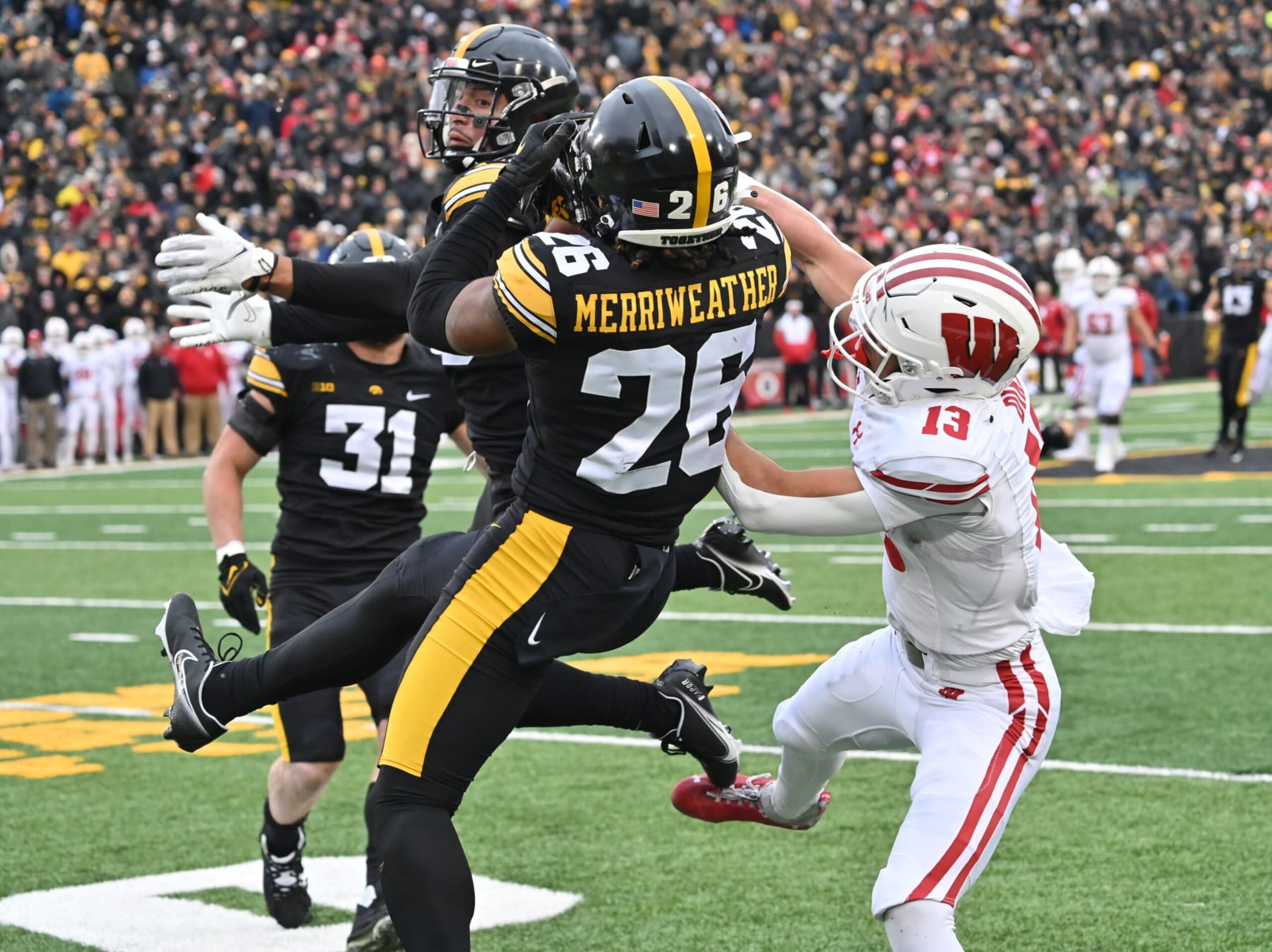 IOWA CITY, IA - NOVEMBER 12: Iowa strong safety Kaevon Merriweather (26) breaks up a pass intended for Wisconsin wide receiver Chimere Dike (13) during a college football game between the Wisconsin Badgers and the Iowa Hawkeyes, November 12, 2022, at Kinnick Stadium, Iowa City, IA. Photo by Keith Gillett/Icon Sportswire via Getty Images.