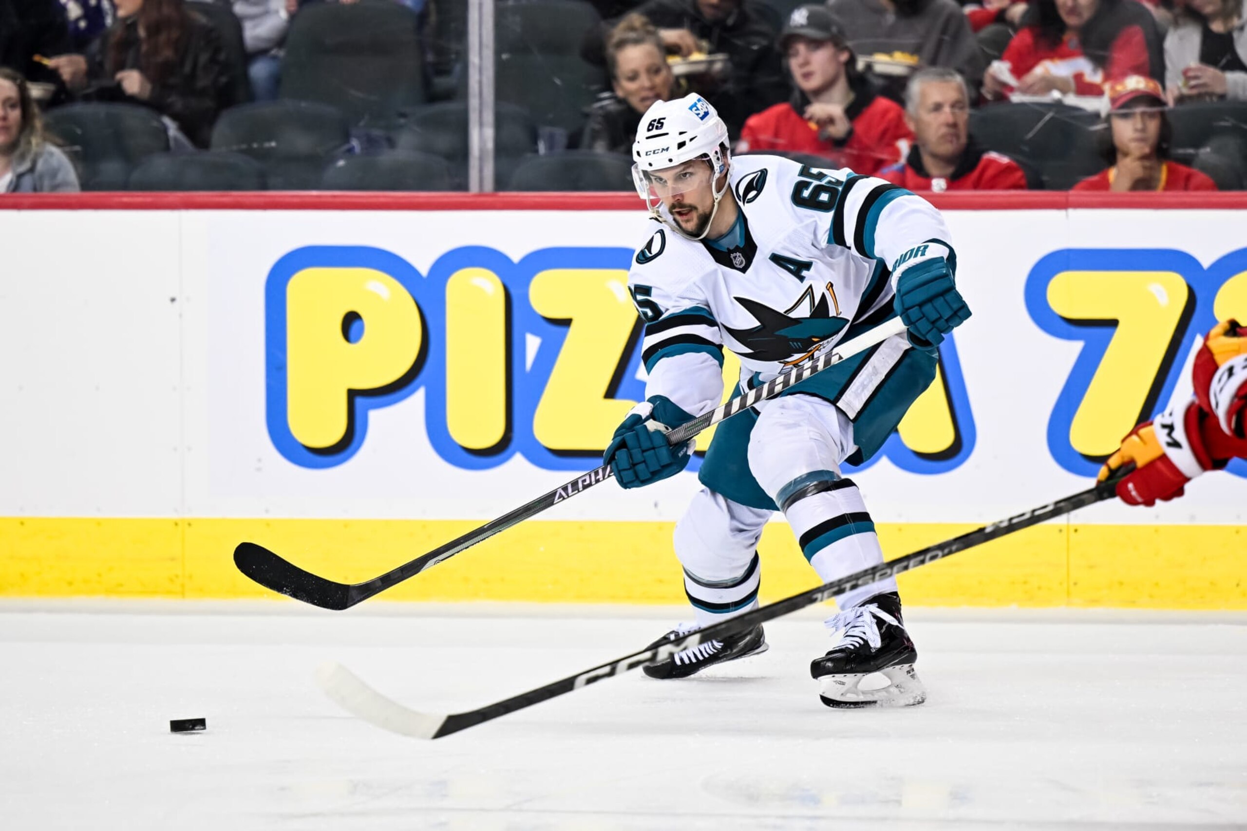 CALGARY, AB - APRIL 12: San Jose Sharks Defenceman Erik Karlsson (65) passes the puck during the second period of an NHL game between the Calgary Flames and the San Jose Sharks on April 12, 2023, at the Scotiabank Saddledome in Calgary, AB. (Photo by Brett Holmes/Icon Sportswire via Getty Images) CALGARY, AB - APRIL 12: San Jose Sharks Defenceman Erik Karlsson (65) passes the puck during the second period of an NHL game between the Calgary Flames and the San Jose Sharks on April 12, 2023, at the Scotiabank Saddledome in Calgary, AB. (Photo by Brett Holmes/Icon Sportswire via Getty Images)