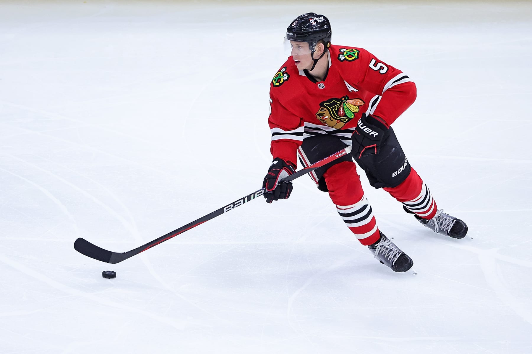 CHICAGO, ILLINOIS - APRIL 13: Connor Murphy #5 of the Chicago Blackhawks controls the puck during a game against the Philadelphia Flyers at the United Center on April 13, 2023 in Chicago, Illinois.  The Flyers defeated the Blackhawks 5-4 in overtime. (Photo by Stacy Revere/Getty Images)