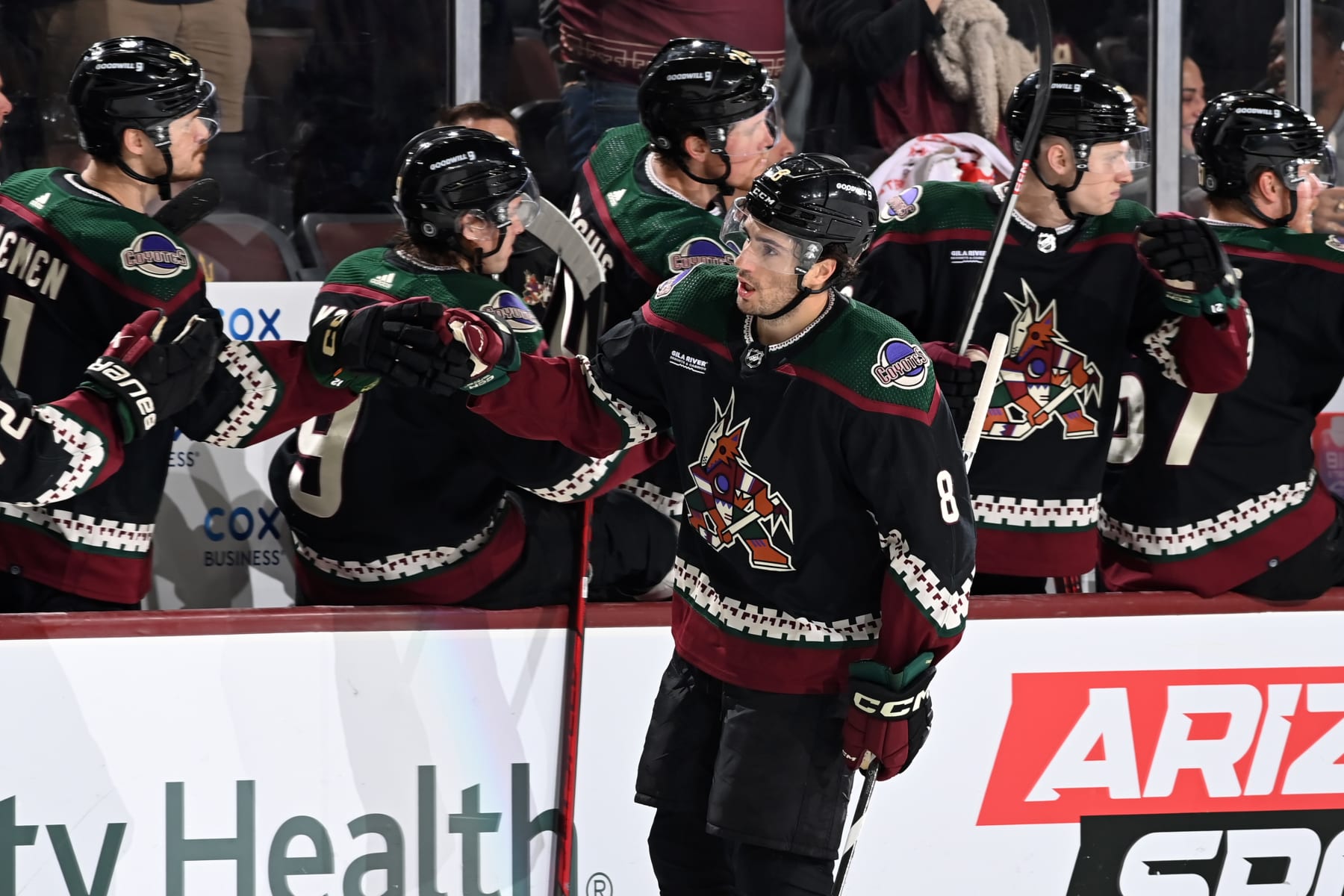 TEMPE, ARIZONA - APRIL 13: Nick Schmaltz #8 of the Arizona Coyotes celebrates with teammates on the bench after scoring his 100th career NHL goal against the Vancouver Canucks during the third period at Mullett Arena on April 13, 2023 in Tempe, Arizona. (Photo by Norm Hall/NHLI via Getty Images)