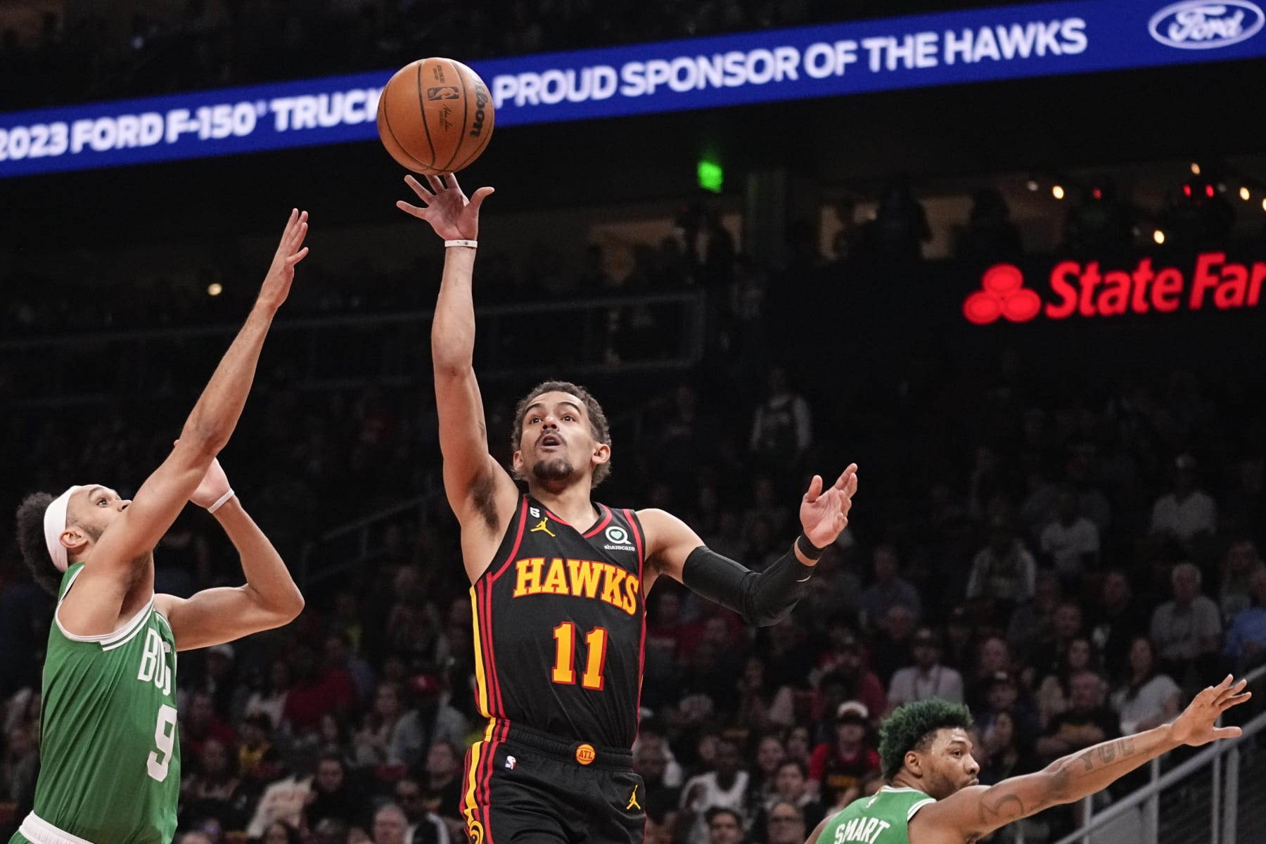 Atlanta Hawks guard Trae Young (11) shoots against Boston Celtics guard Derrick White (9) during the first half of Game 3 of a first-round NBA basketball playoff series, Friday, April 21, 2023, in Atlanta. (AP Photo/Brynn Anderson)