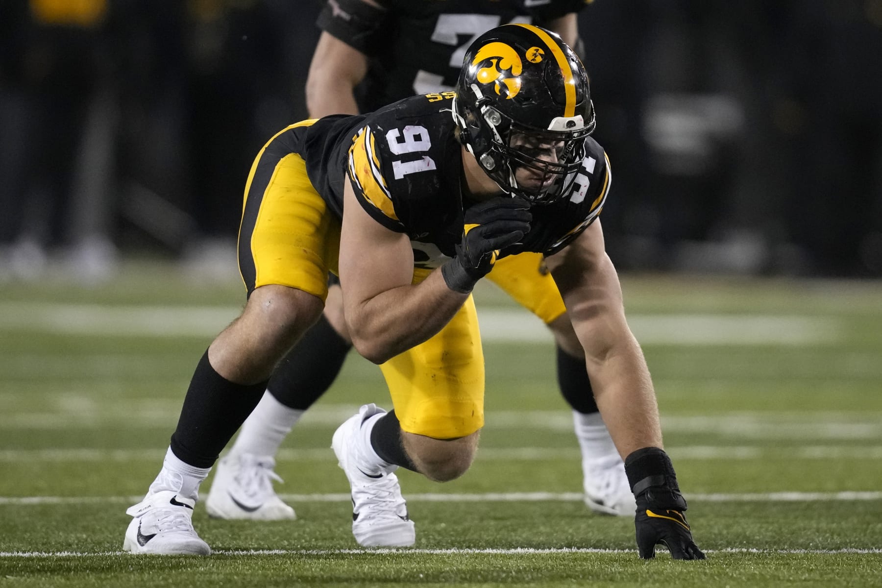 Iowa defensive lineman Lukas Van Ness gets set for a play during the second half of an NCAA college football game against Nebraska, Friday, Nov. 25, 2022, in Iowa City, Iowa. (AP Photo/Charlie Neibergall)