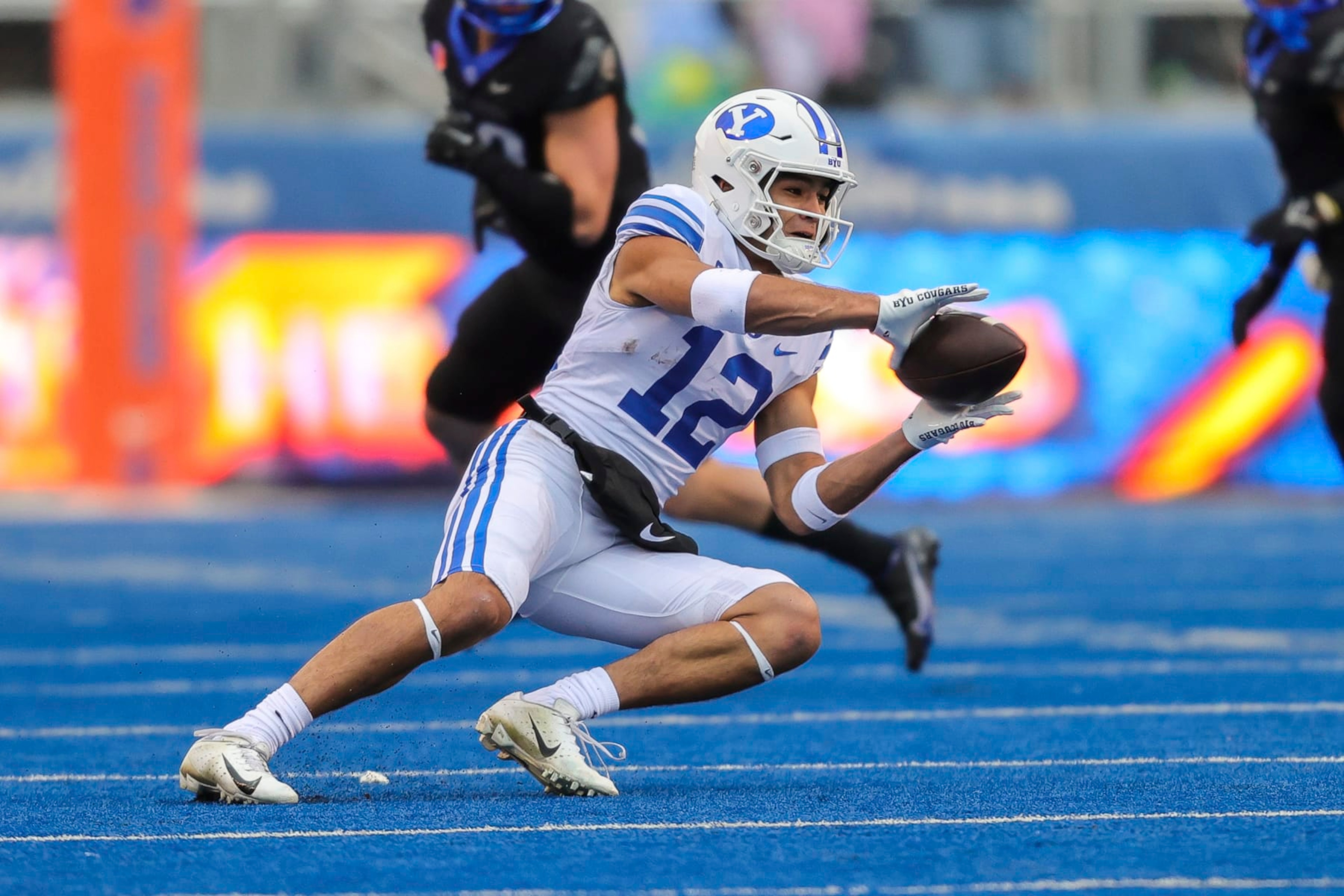 BYU wide receiver Puka Nacua (12) catches the ball against Boise State in the first half of an NCAA college football game, Saturday, Nov. 5, 2022, in Boise, Idaho. (AP Photo/Steve Conner) BYU wide receiver Puka Nacua (12) catches the ball against Boise State in the first half of an NCAA college football game, Saturday, Nov. 5, 2022, in Boise, Idaho. (AP Photo/Steve Conner)