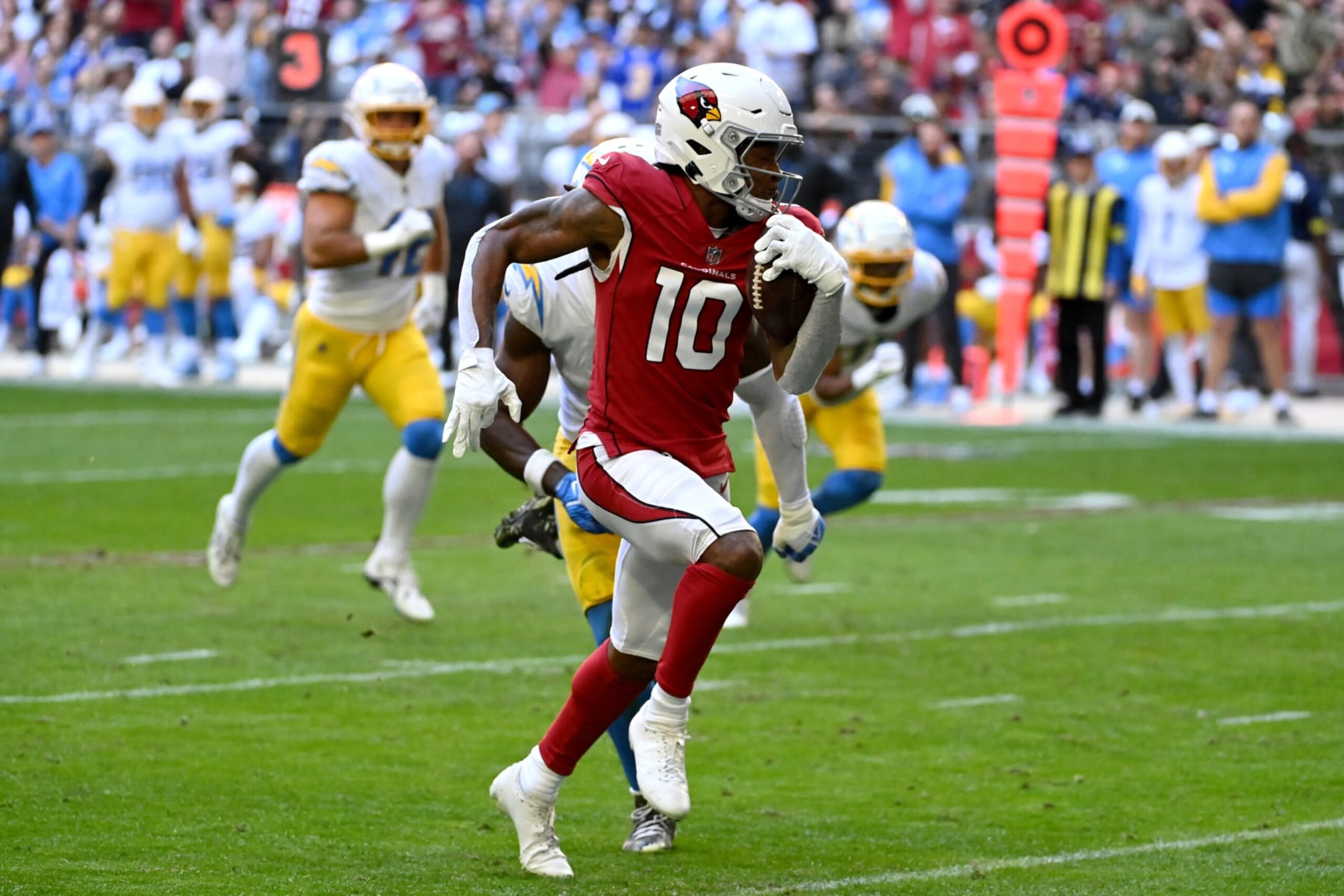 GLENDALE, ARIZONA - NOVEMBER 27: DeAndre Hopkins #10 of the Arizona Cardinals runs with a touchdown pass in the first quarter of a game against the Los Angeles Chargers at State Farm Stadium on November 27, 2022 in Glendale, Arizona. (Photo by Norm Hall/Getty Images)