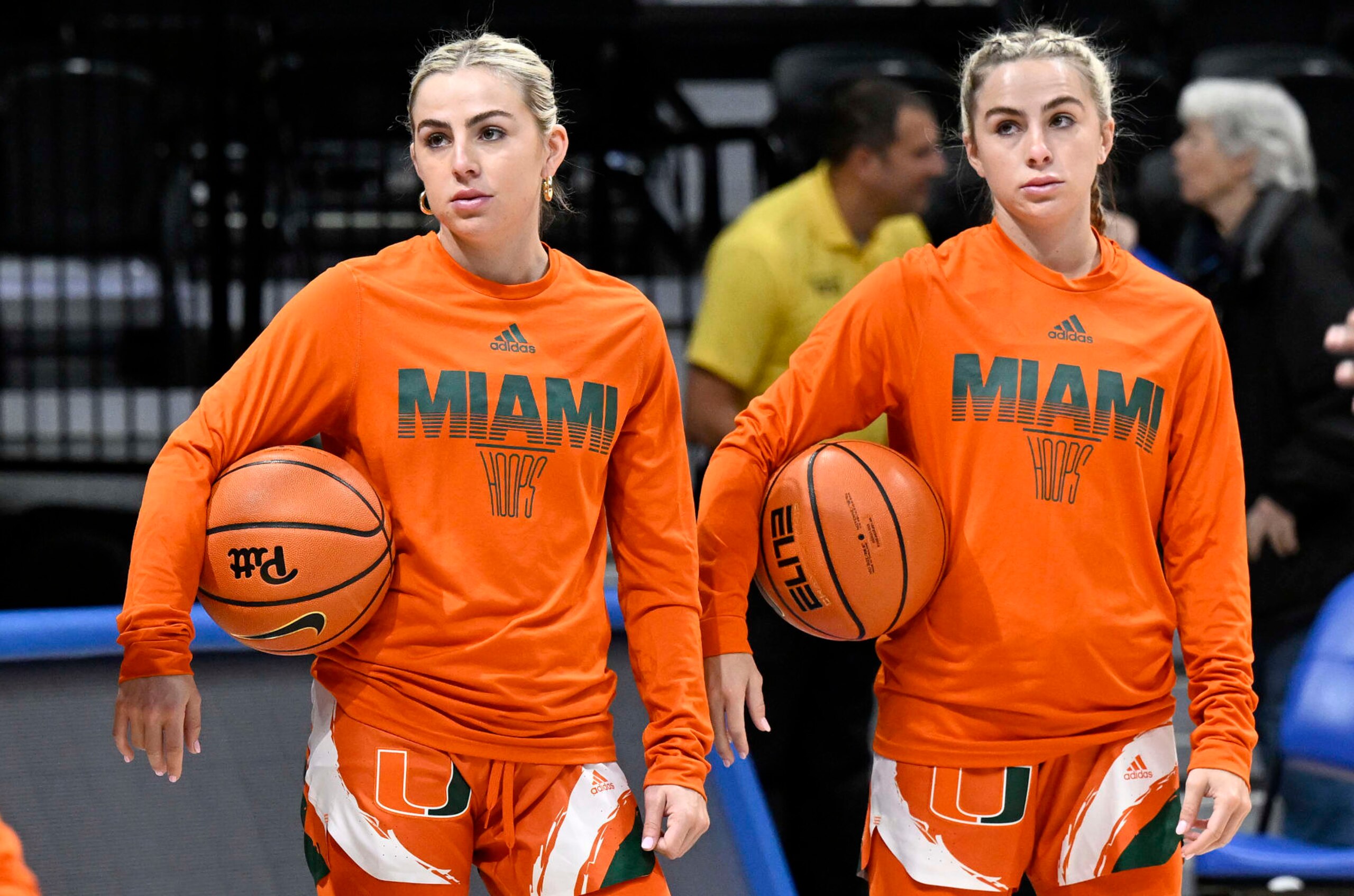 PITTSBURGH, PENNSYLVANIA - JANUARY 01: Haley Cavinder #14 (L) and Hanna Cavinder #15 (R) of the Miami Hurricanes warm up before the game against the Pittsburgh Panthers at Petersen Events Center on January 01, 2023 in Pittsburgh, Pennsylvania. (Photo by G Fiume/Getty Images)