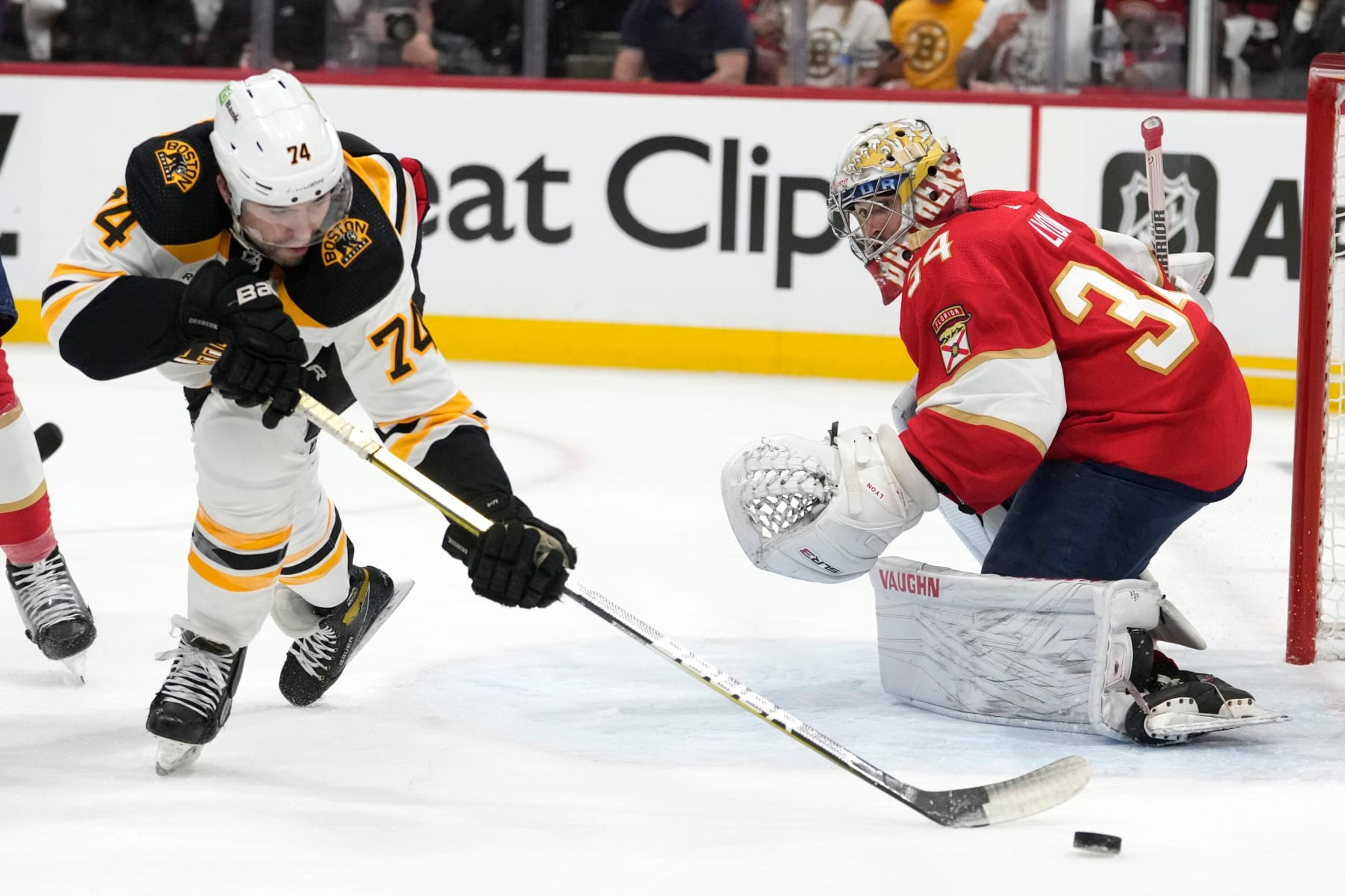Boston Bruins left wing Jake DeBrusk (74) passes the puck as Florida Panthers goaltender Alex Lyon (34) defends during the first period of Game 3 of an NHL hockey Stanley Cup first-round playoff series, Friday, April 21, 2023, in Sunrise, Fla. (AP Photo/Lynne Sladky) Boston Bruins left wing Jake DeBrusk (74) passes the puck as Florida Panthers goaltender Alex Lyon (34) defends during the first period of Game 3 of an NHL hockey Stanley Cup first-round playoff series, Friday, April 21, 2023, in Sunrise, Fla. (AP Photo/Lynne Sladky)