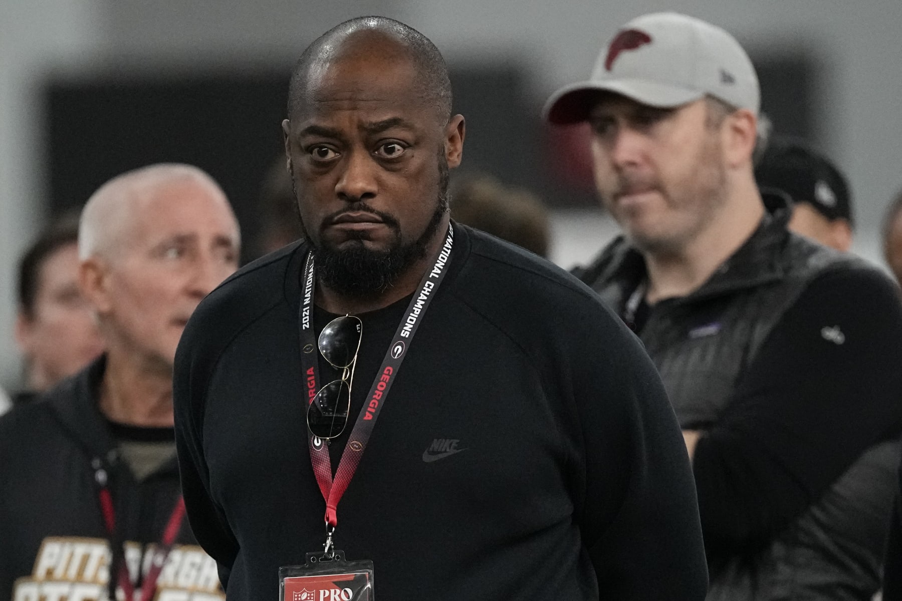 Pittsburgh Steelers head coach Mike Tomlin, center, and Falcons head coach Arthur Smith, right, watch football drills during Georgia's Pro Day, Wednesday, March 15, 2023, in Athens, Ga. (AP Photo/John Bazemore)