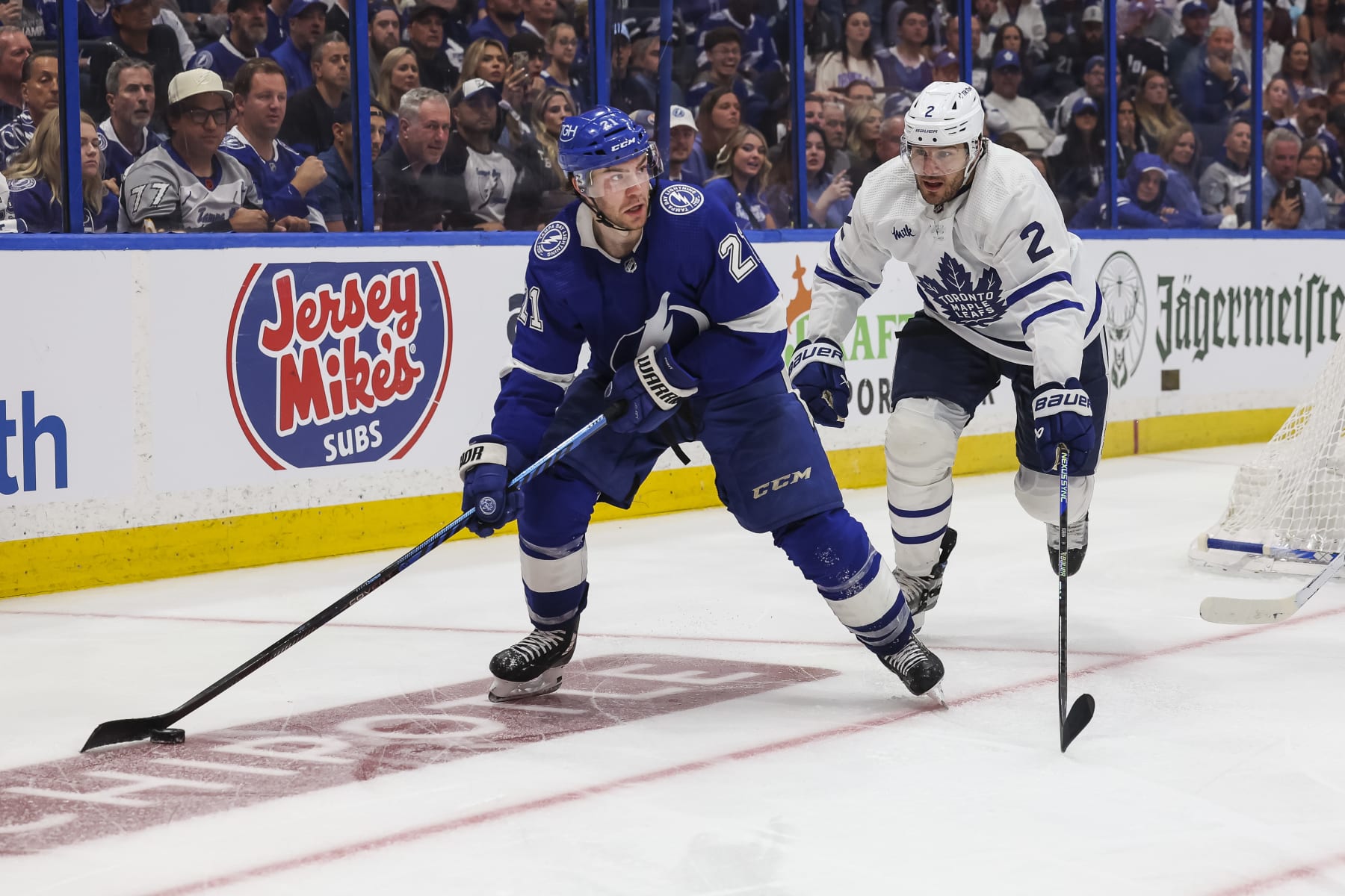 TAMPA, FL - APRIL 22: Brayden Point #21 of the Tampa Bay Lightning against Luke Schenn #2 of the Toronto Maple Leafs during overtime in Game Three of the First Round of the 2023 Stanley Cup Playoffs at Amalie Arena on April 22, 2023 in Tampa, Florida. (Photo by Mark LoMoglio/NHLI via Getty Images)