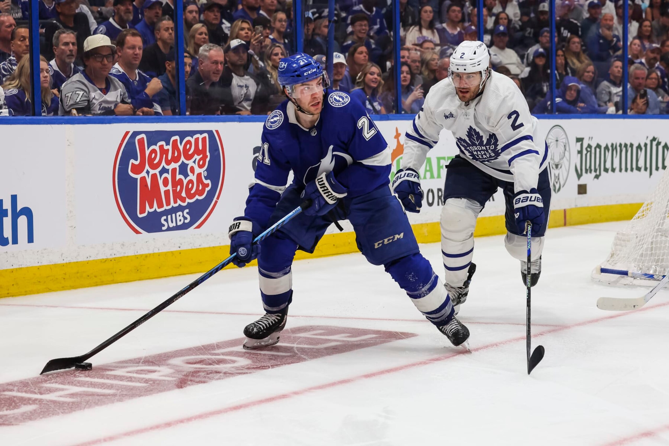 TAMPA, FL - APRIL 22: Brayden Point #21 of the Tampa Bay Lightning against Luke Schenn #2 of the Toronto Maple Leafs during overtime in Game Three of the First Round of the 2023 Stanley Cup Playoffs at Amalie Arena on April 22, 2023 in Tampa, Florida. (Photo by Mark LoMoglio/NHLI via Getty Images)