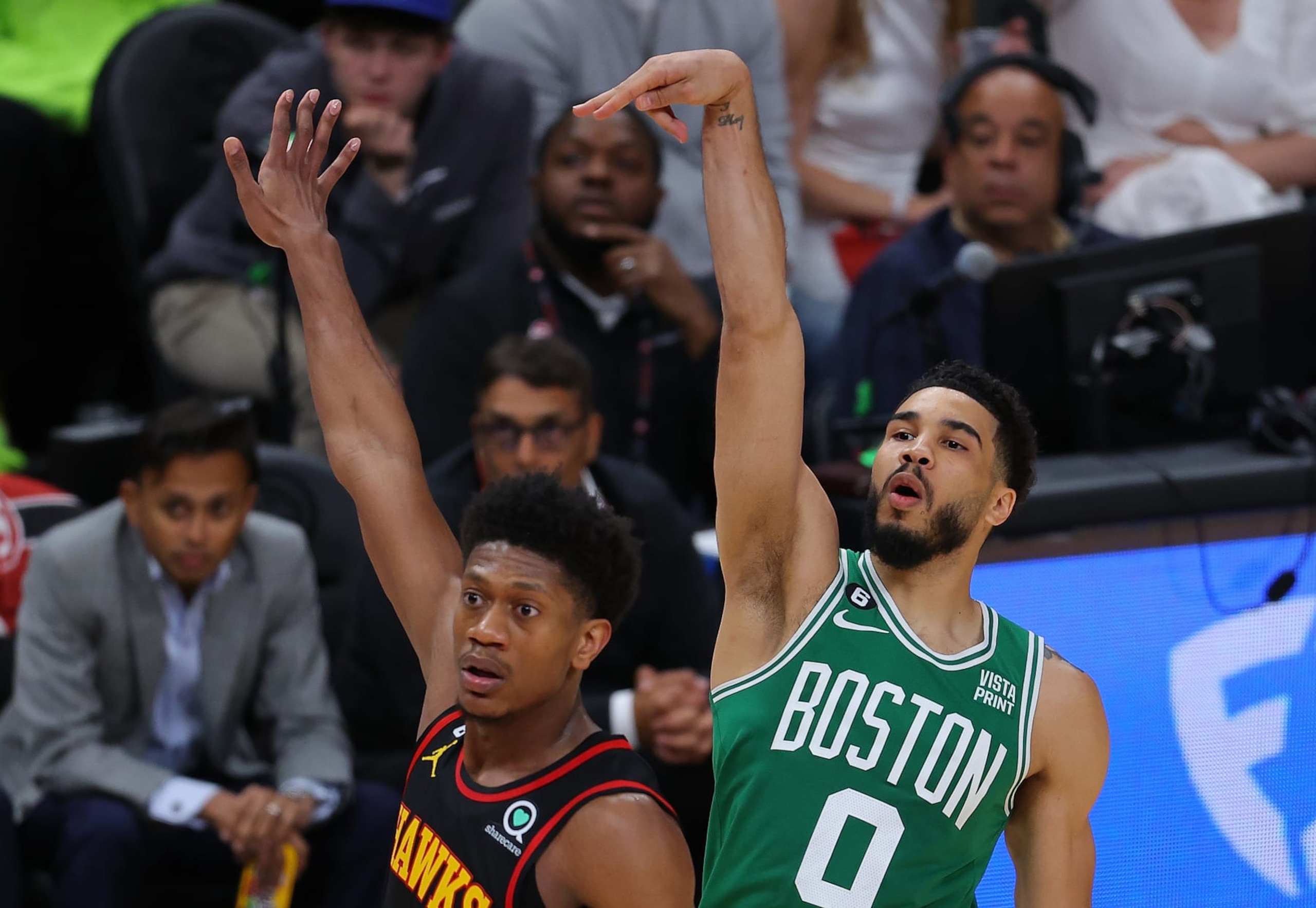 ATLANTA, GEORGIA - APRIL 23:  Jayson Tatum #0 of the Boston Celtics reacts as he hits a three-point basket against De'Andre Hunter #12 of the Atlanta Hawks during the fourth quarter of Game Four of the Eastern Conference First Round Playoffs at State Farm Arena on April 23, 2023 in Atlanta, Georgia. NOTE TO USER: User expressly acknowledges and agrees that, by downloading and or using this photograph, User is consenting to the terms and conditions of the Getty Images License Agreement.  (Photo by Kevin C. Cox/Getty Images)