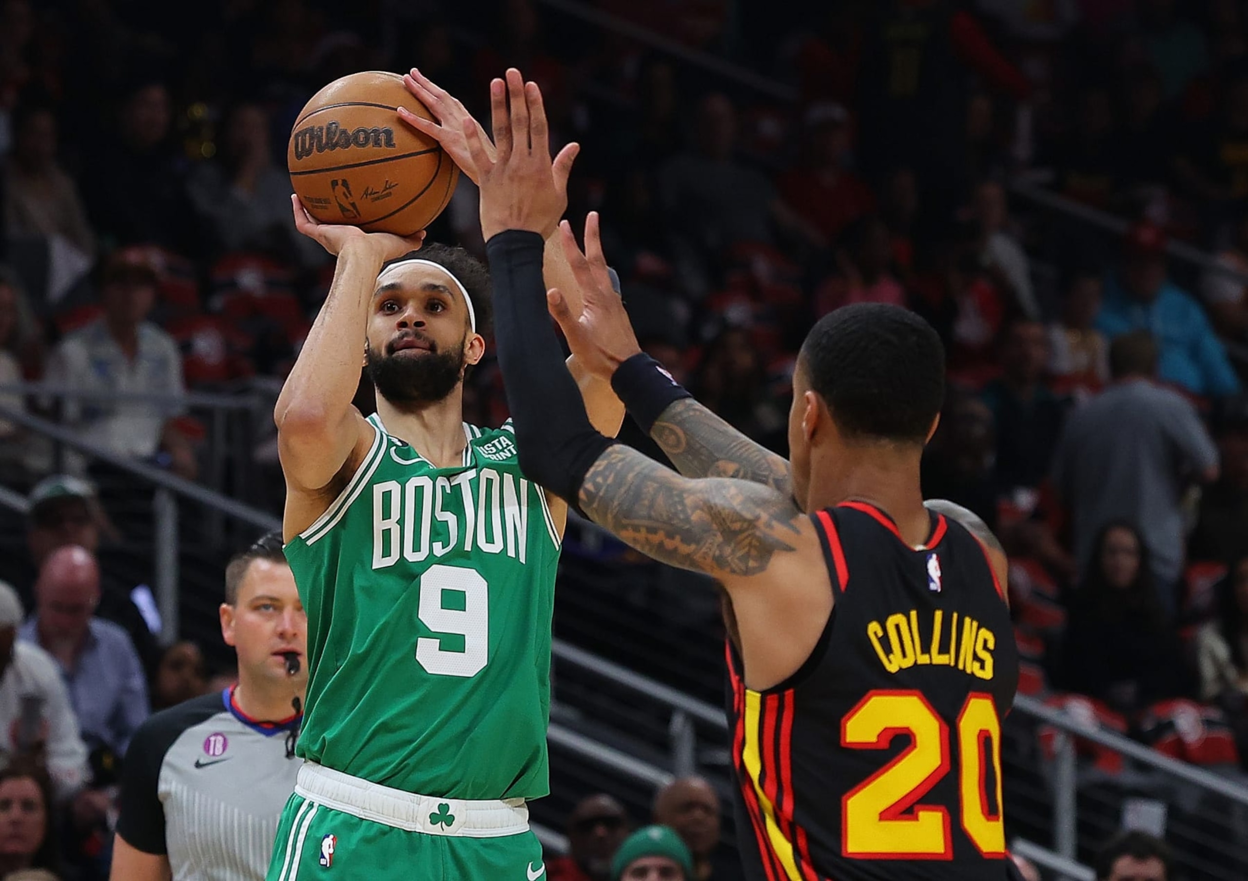 ATLANTA, GEORGIA - APRIL 23:  Derrick White #9 of the Boston Celtics attempts a shot against John Collins #20 of the Atlanta Hawks during the first quarter of Game Four of the Eastern Conference First Round Playoffs at State Farm Arena on April 23, 2023 in Atlanta, Georgia. NOTE TO USER: User expressly acknowledges and agrees that, by downloading and or using this photograph, User is consenting to the terms and conditions of the Getty Images License Agreement.  (Photo by Kevin C. Cox/Getty Images)