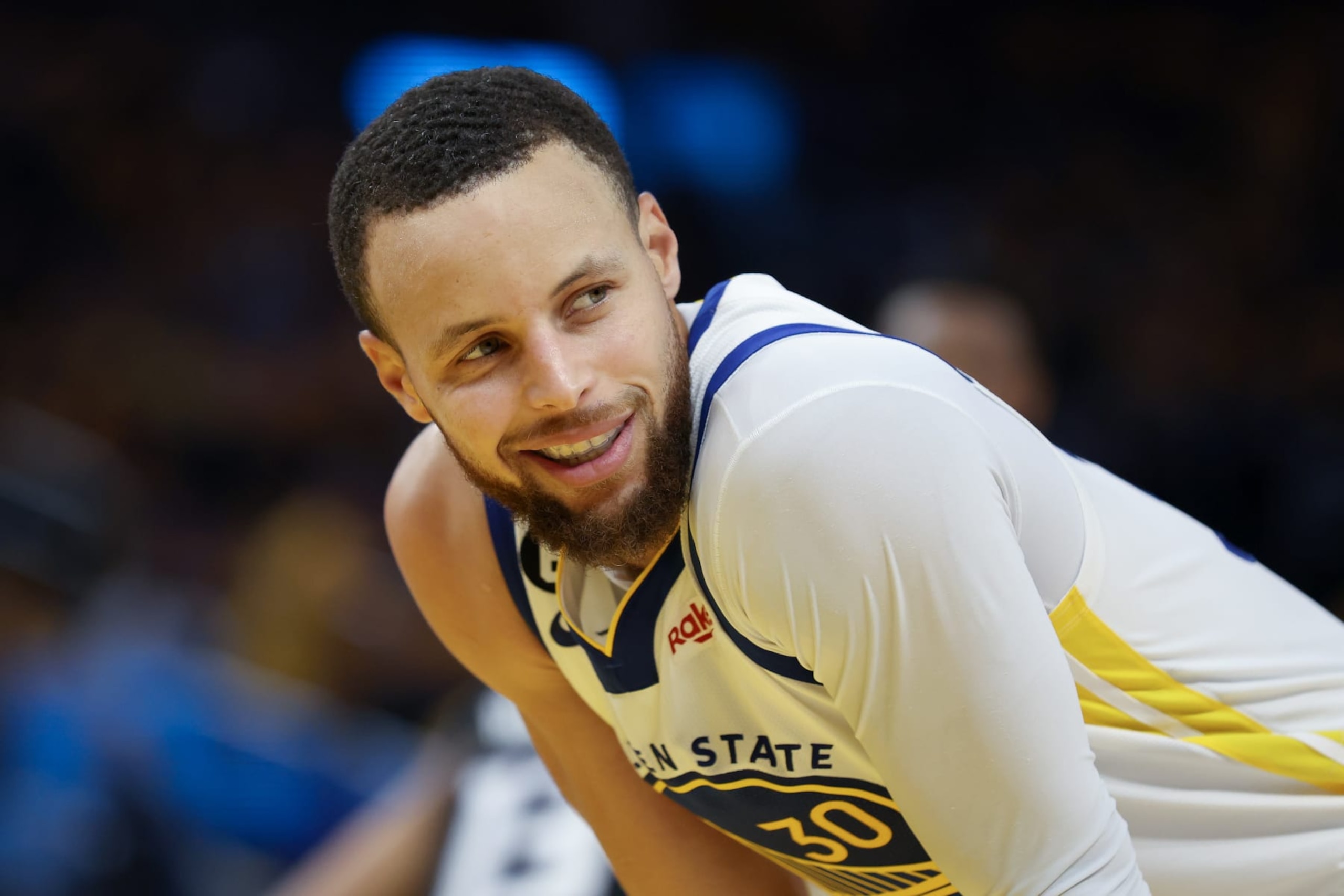 SAN FRANCISCO, CALIFORNIA - APRIL 23: Stephen Curry #30 of the Golden State Warriors smiles as he looks to the Sacramento Kings bench during Game Four of the Western Conference First Round Playoffs at Chase Center on April 23, 2023 in San Francisco, California. NOTE TO USER: User expressly acknowledges and agrees that, by downloading and or using this photograph, User is consenting to the terms and conditions of the Getty Images License Agreement. (Photo by Ezra Shaw/Getty Images)
