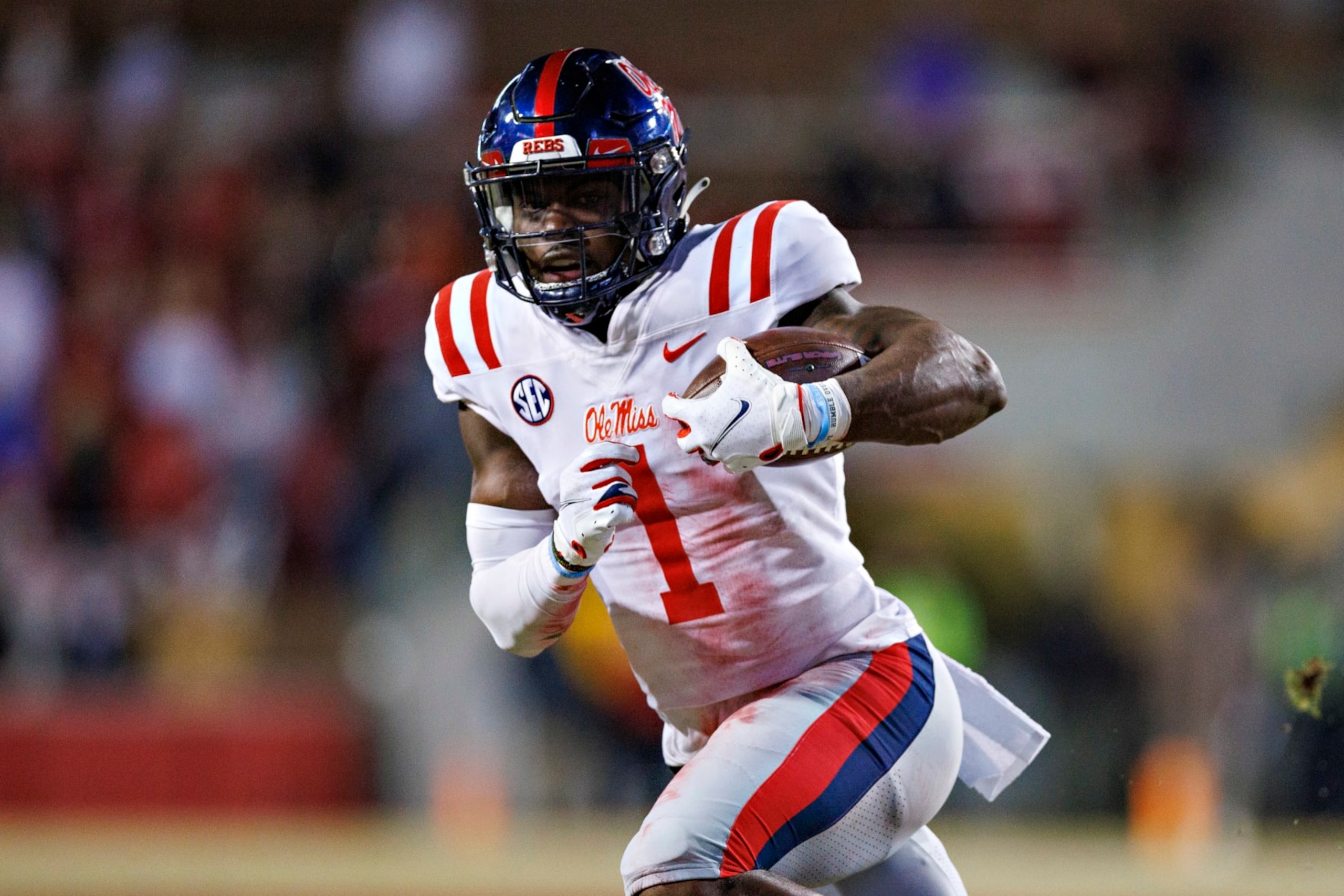 FAYETTEVILLE, ARKANSAS - NOVEMBER 19: Jonathan Mingo #1 of the Mississippi Rebels runs the ball during a game against the Arkansas Razorbacks at Donald W. Reynolds Razorback Stadium on November 19, 2022 in Fayetteville, Arkansas. The Razorbacks defeated the Rebels 42-27.  (Photo by Wesley Hitt/Getty Images)