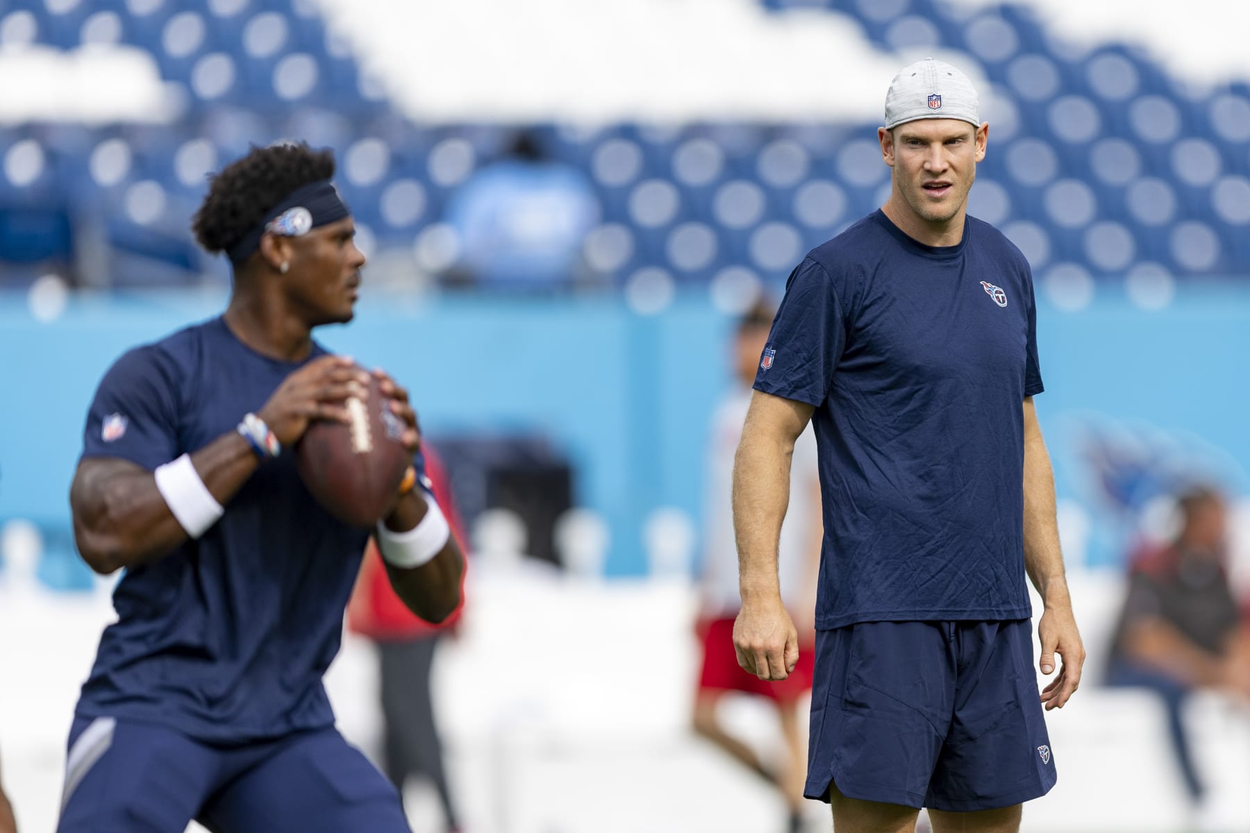 NASHVILLE, TENNESSEE - AUGUST 20: Malik Willis #7 warms up under the watchful eyes of Ryan Tannheill #17 of the Tennessee Titans before a preseason game against the Tennessee Titans at Nissan Stadium on August 20, 2022 in Nashville, Tennessee. The Titans defeated the Buccaneers 13-3.  (Photo by Wesley Hitt/Getty Images)