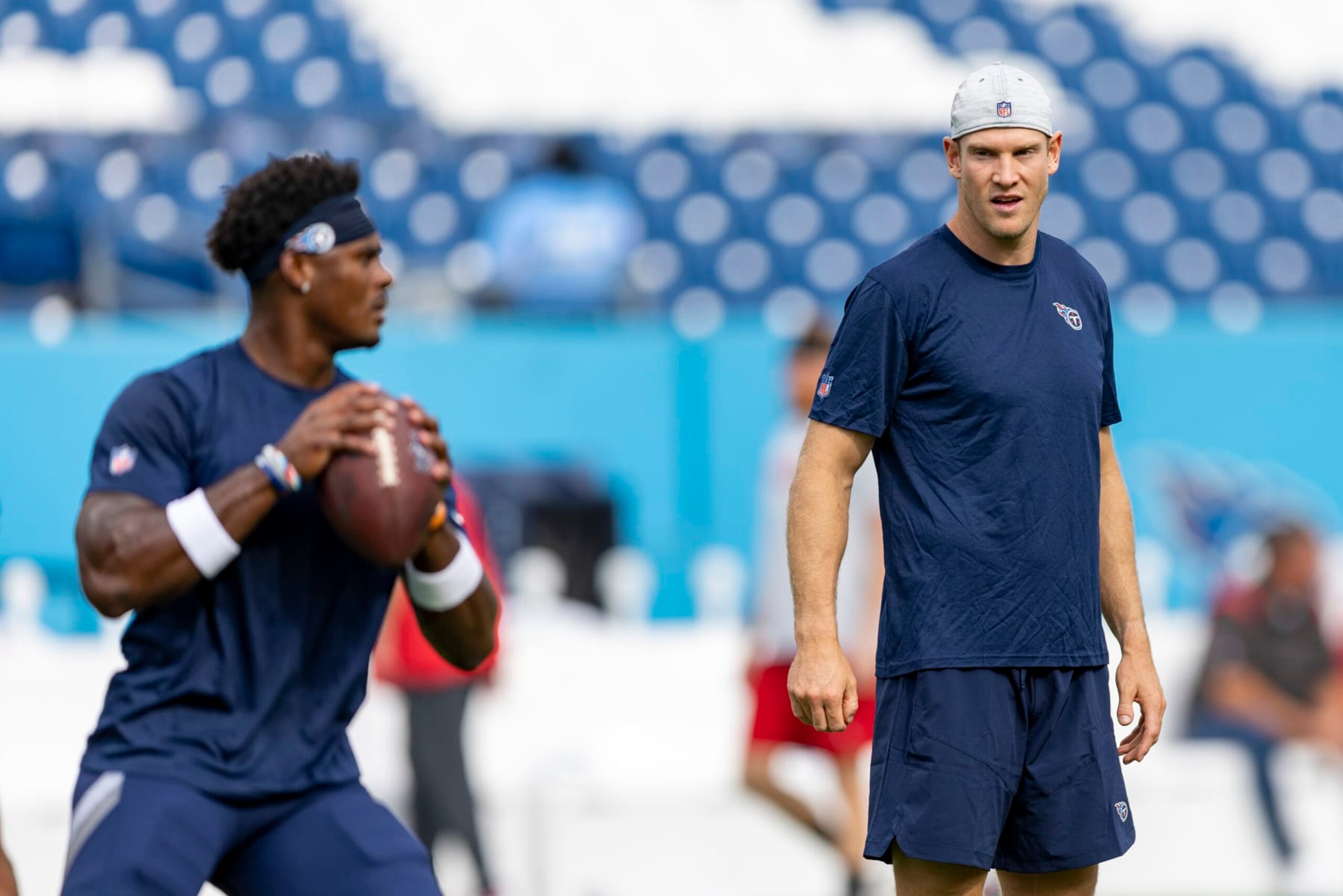 NASHVILLE, TENNESSEE - AUGUST 20: Malik Willis #7 warms up under the watchful eyes of Ryan Tannheill #17 of the Tennessee Titans before a preseason game against the Tennessee Titans at Nissan Stadium on August 20, 2022 in Nashville, Tennessee. The Titans defeated the Buccaneers 13-3.  (Photo by Wesley Hitt/Getty Images)