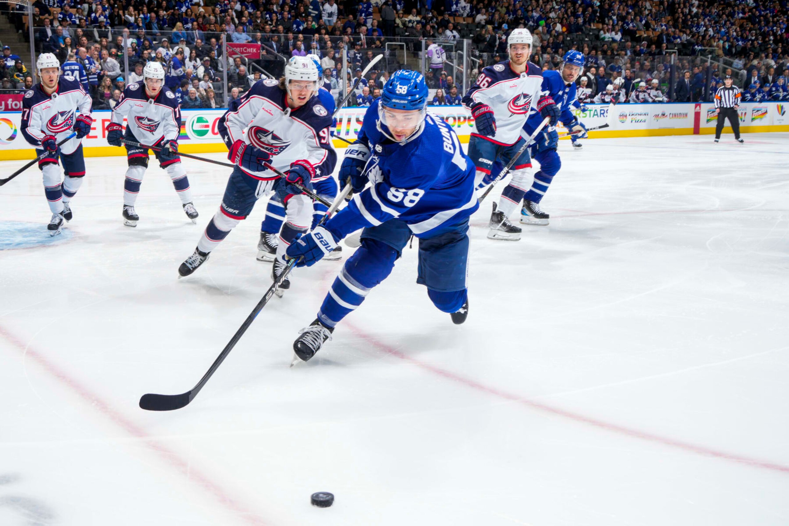 TORONTO, ON - APRIL 4: Michael Bunting #58 of the Toronto Maple Leafs plays the puck against the Columbus Blue Jackets during the first period at the Scotiabank Arena on April 4, 2023 in Toronto, Ontario, Canada. (Photo by Mark Blinch/NHLI via Getty Images)