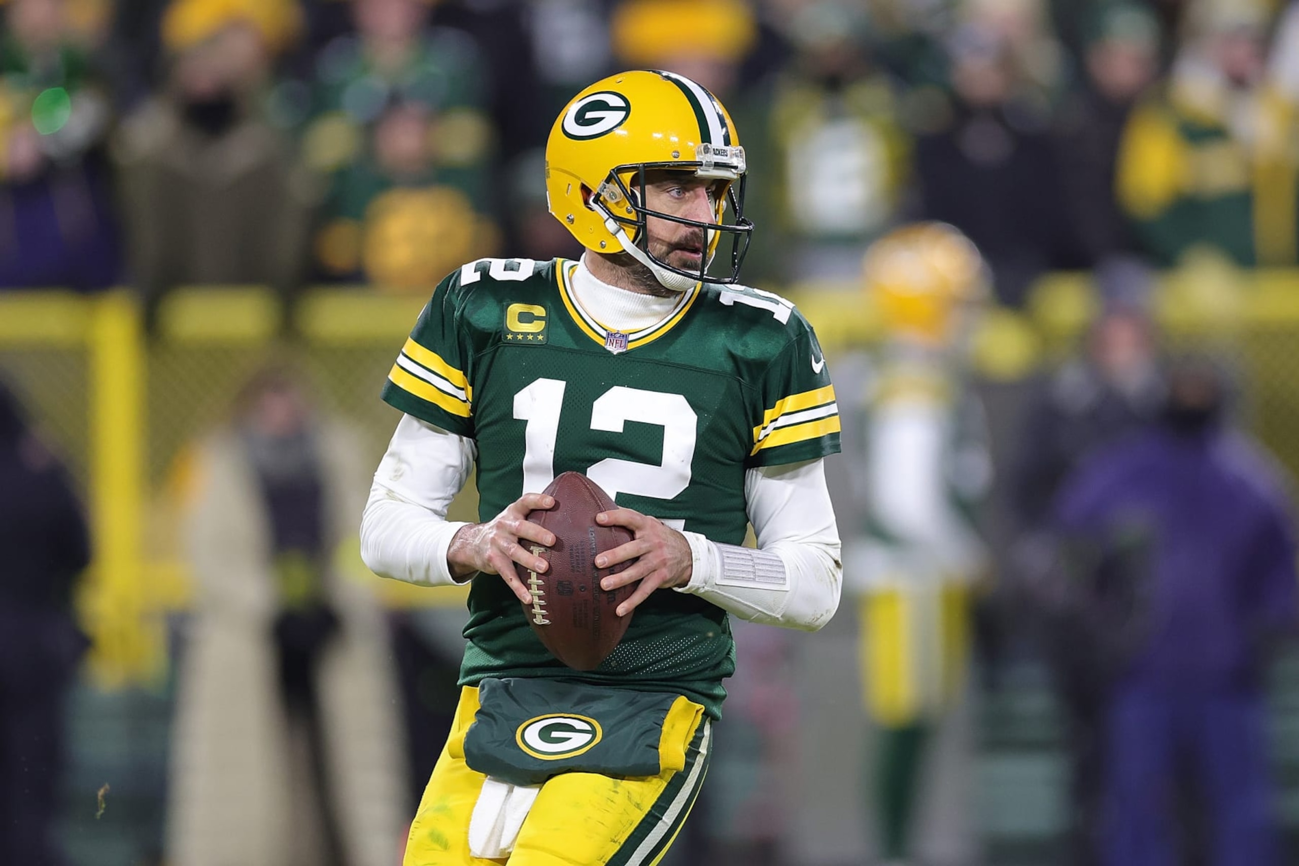 GREEN BAY, WISCONSIN - JANUARY 08: Aaron Rodgers #12 of the Green Bay Packers drops back to pass during a game against the Detroit Lions at Lambeau Field on January 08, 2023 in Green Bay, Wisconsin. The Lions defeated the Packers 20-16. (Photo by Stacy Revere/Getty Images)