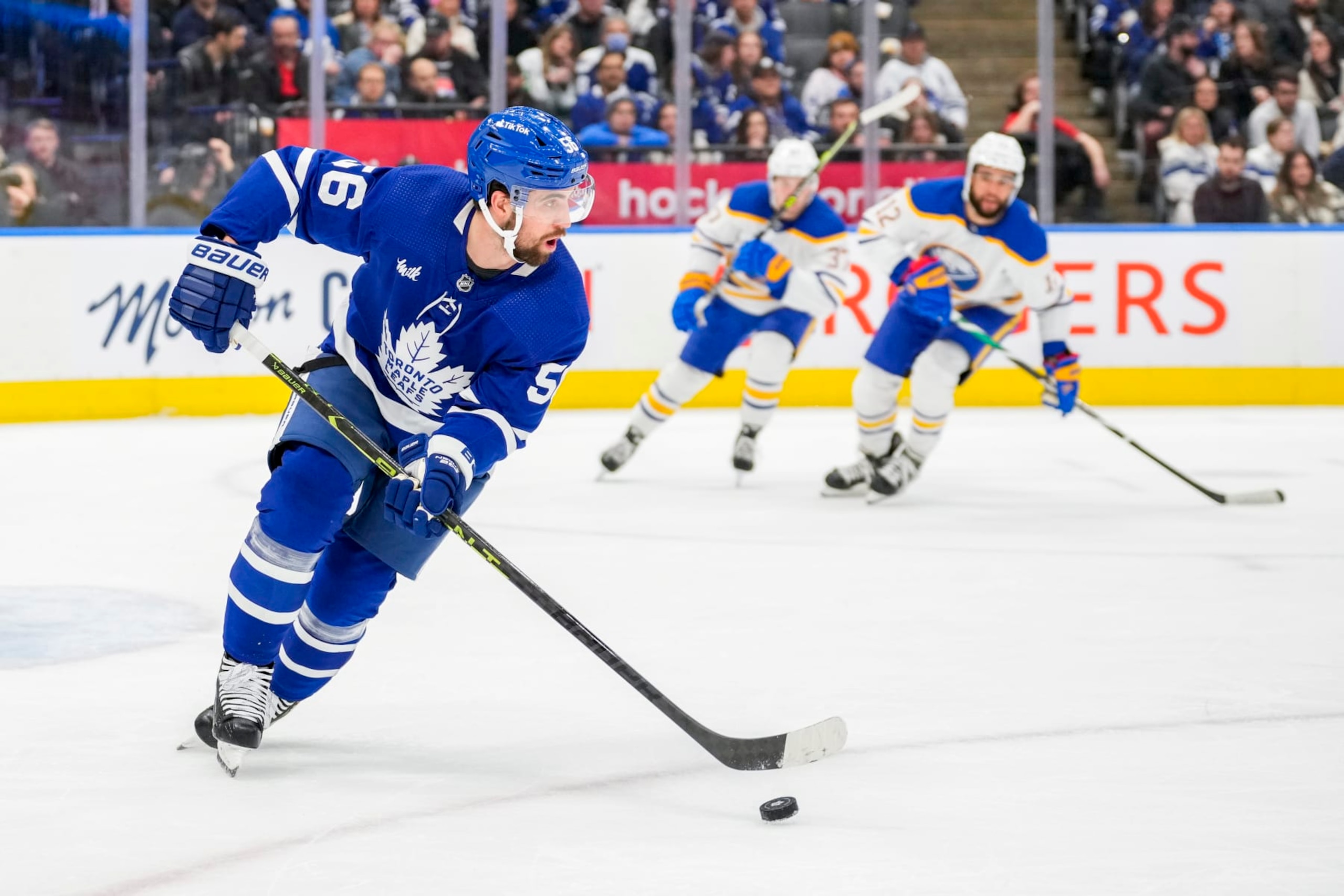 TORONTO, ON - MARCH 13: Erik Gustafsson #56 of the Toronto Maple Leafs plays the puck against the Buffalo Sabres during the first period at the Scotiabank Arena on March 13, 2023 in Toronto, Ontario, Canada. (Photo by Kevin Sousa/NHLI via Getty Images)