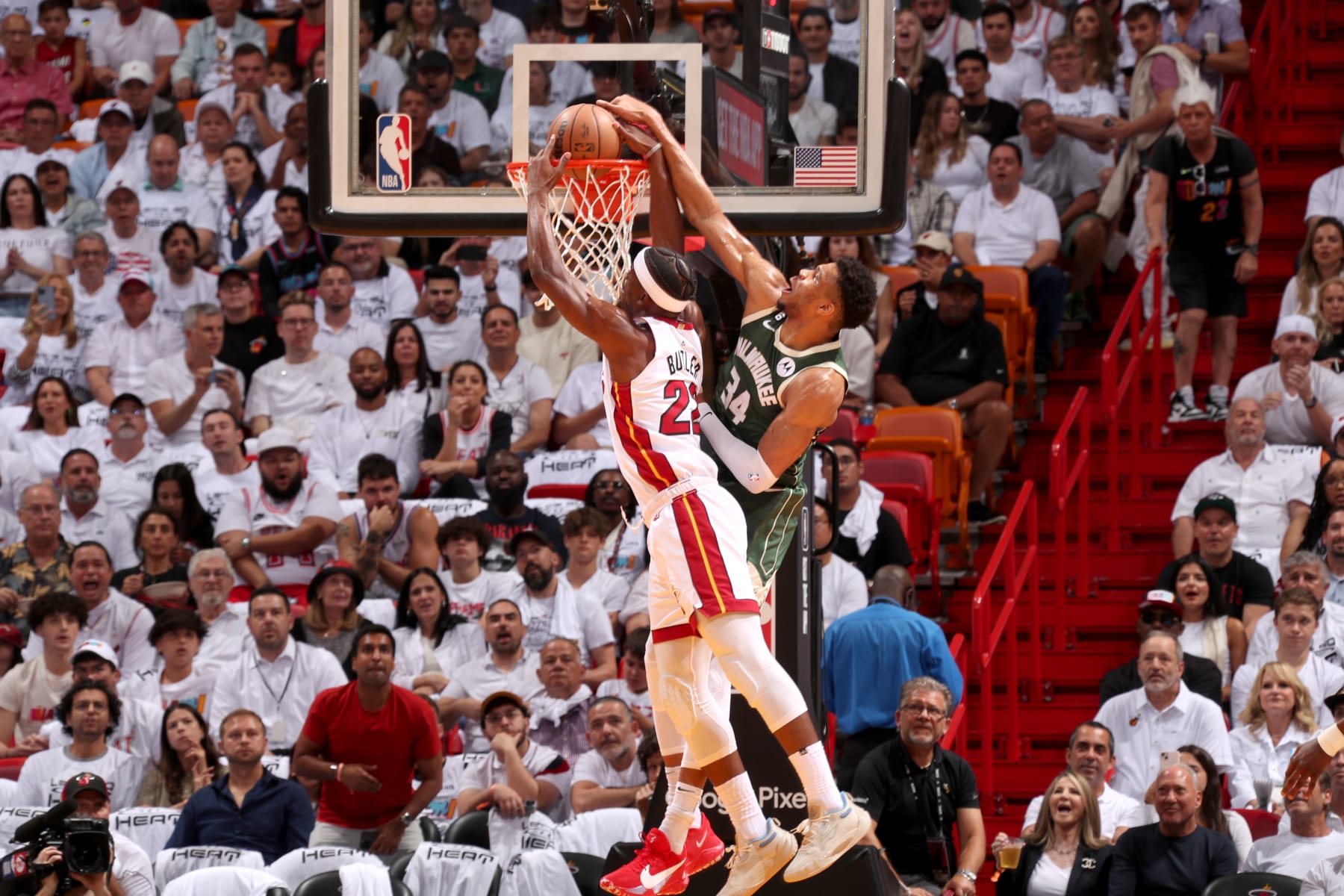 MIAMI, FL - APRIL 24:  Jimmy Butler #22 of the Miami Heat dunks the ball against Giannis Antetokounmpo #34 of the Milwaukee Bucks during Round 1 Game 4 of the 2023 NBA Playoffs on April 24, 2023 at FTX Arena in Miami, Florida. NOTE TO USER: User expressly acknowledges and agrees that, by downloading and or using this Photograph, user is consenting to the terms and conditions of the Getty Images License Agreement. Mandatory Copyright Notice: Copyright 2023 NBAE (Photo by Issac Baldizon/NBAE via Getty Images)