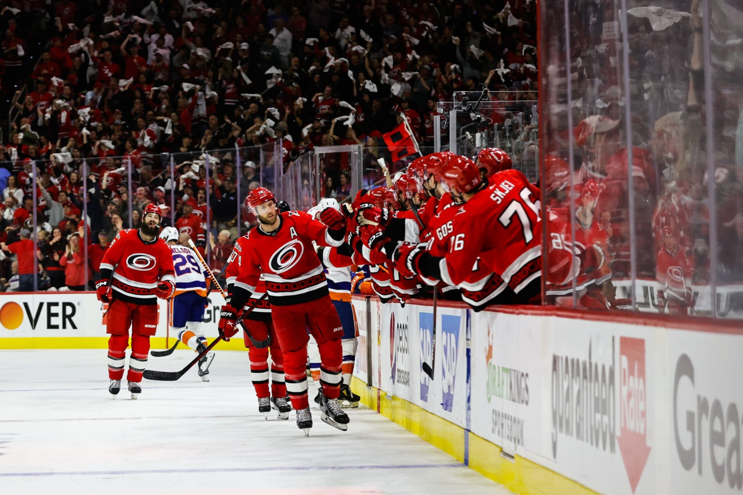 RALEIGH, NC - APRIL 19: Jaccob Slavin #74 of the Carolina Hurricanes scores a goal and celebrates with his teammates against the New York Islanders during the third period of Eastern Conference Game Two of the First Round of the 2023 Stanley Cup Playoffs at PNC Arena on April 19, 2023 in Raleigh, North Carolina. (Photo by Jaylynn Nash/Getty Images)