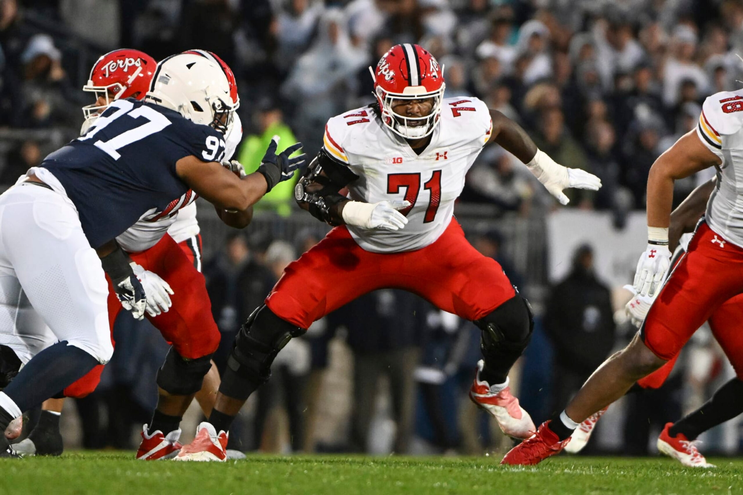 Maryland offensive lineman Jaelyn Duncan (71) looks to block Penn State defensive tackle PJ Mustipher (97) during the first half of an NCAA college football game, Saturday, Nov. 12, 2022, in State College, Pa. (AP Photo/Barry Reeger)