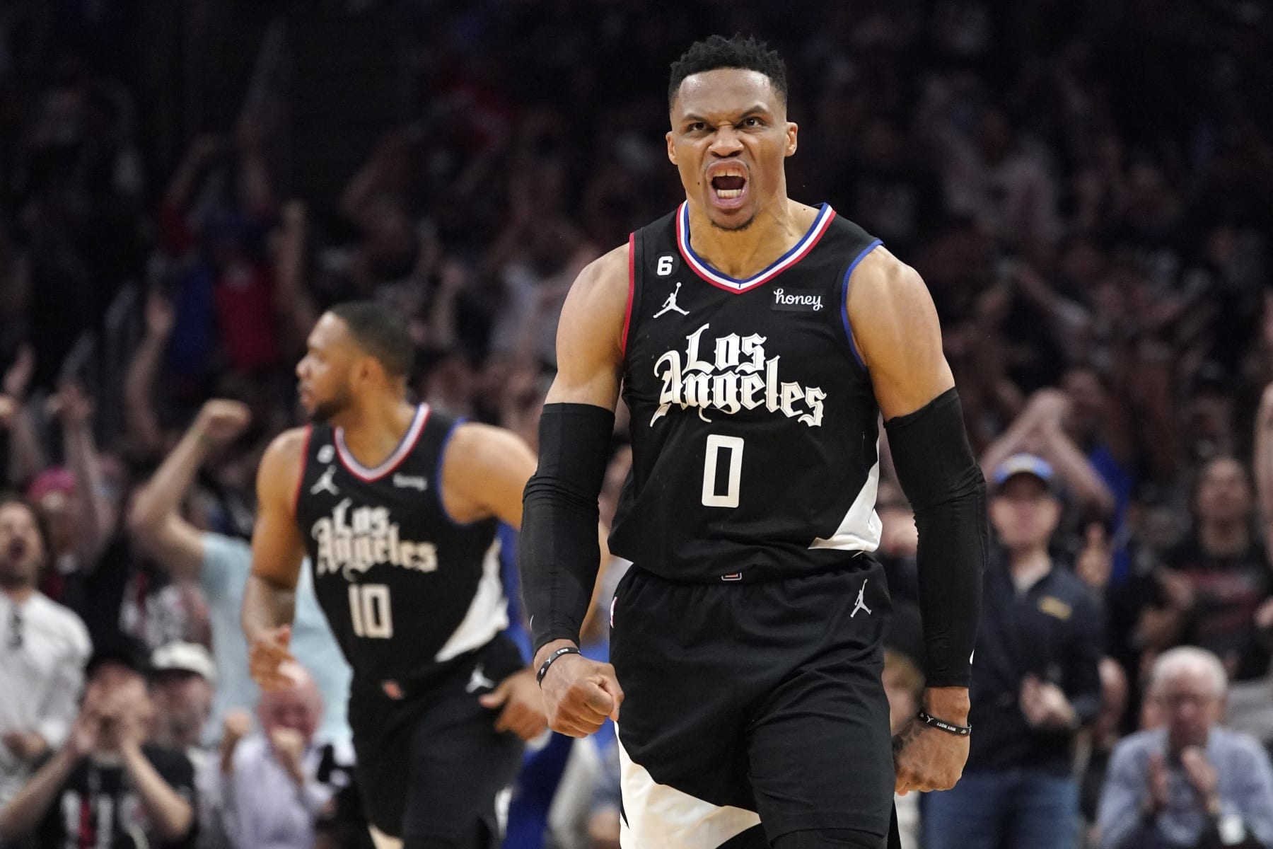 Los Angeles Clippers guard Russell Westbrook, right, celebrates after scoring as guard Eric Gordon runs behind during the second half in Game 4 of a first-round NBA basketball playoff series against the Phoenix Suns Saturday, April 22, 2023, in Los Angeles. (AP Photo/Mark J. Terrill)