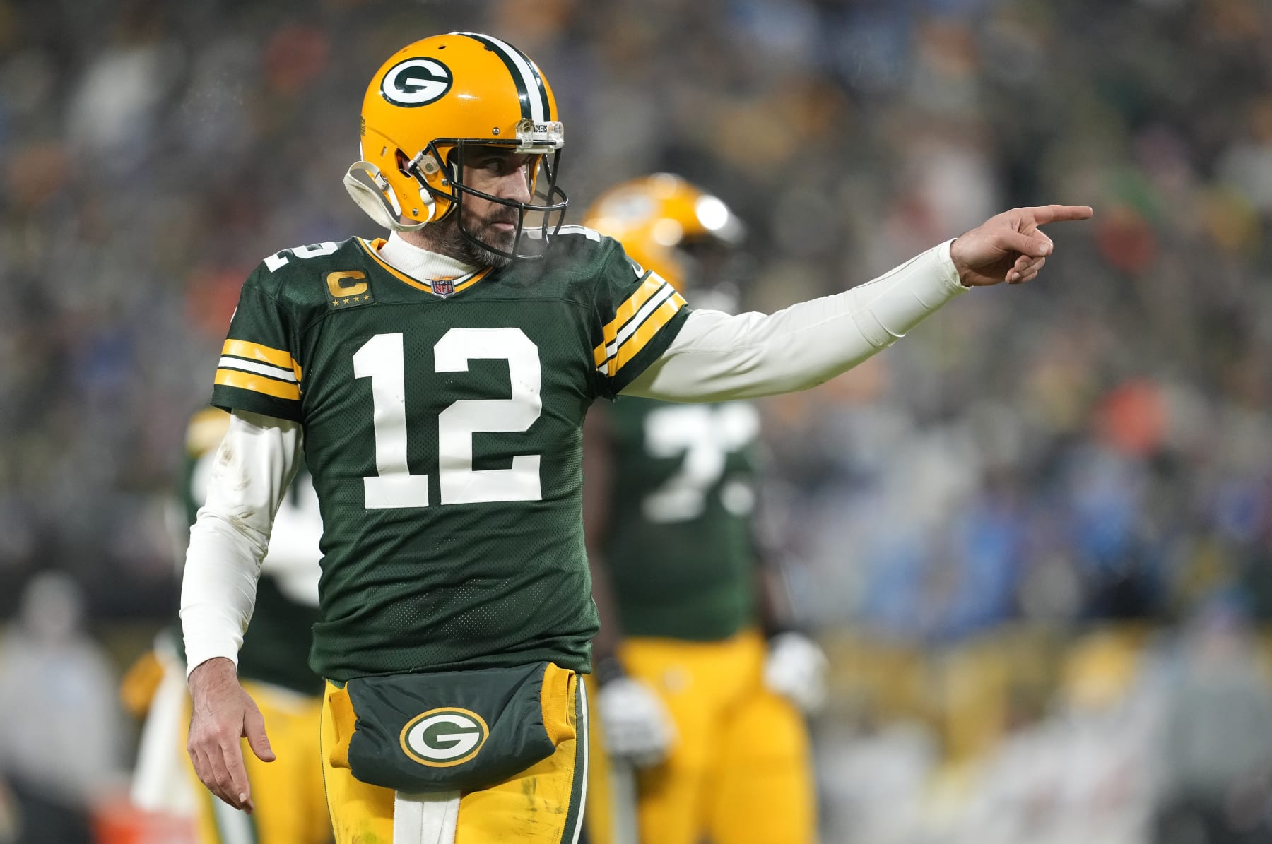 GREEN BAY, WISCONSIN - JANUARY 08: Aaron Rodgers #12 of the Green Bay Packers reacts after throwing a touchdown pass during the third quarter against the Detroit Lions at Lambeau Field on January 08, 2023 in Green Bay, Wisconsin. (Photo by Patrick McDermott/Getty Images)