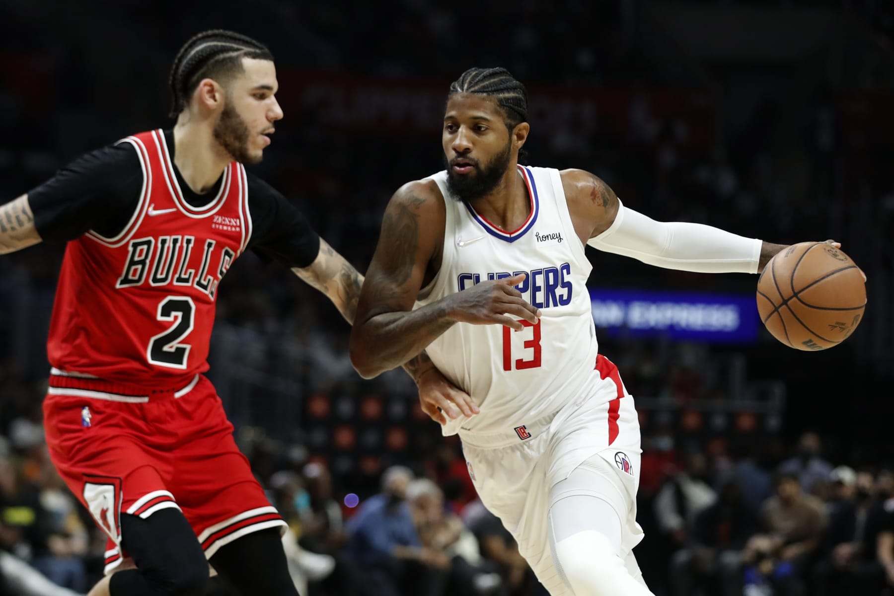 Los Angeles Clippers guard Paul George, right, drives to the basket against Chicago Bulls guard Lonzo Ball during the first half of an NBA basketball game Sunday, Nov. 14, 2021, in Los Angeles. (AP Photo/Alex Gallardo) Los Angeles Clippers guard Paul George, right, drives to the basket against Chicago Bulls guard Lonzo Ball during the first half of an NBA basketball game Sunday, Nov. 14, 2021, in Los Angeles. (AP Photo/Alex Gallardo)