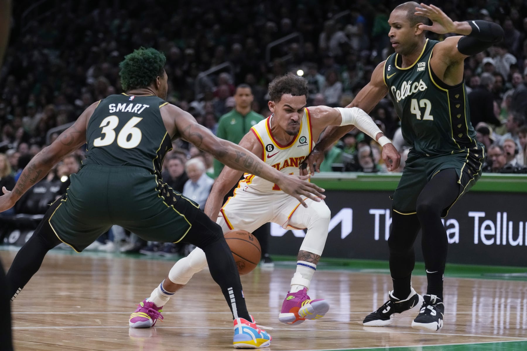 Atlanta Hawks guard Trae Young, center, drives to the basket against Boston Celtics guard Marcus Smart (36) and center Al Horford (42) during the first half of Game 5 in a first-round NBA basketball playoff series Tuesday, April 25, 2023, in Boston. (AP Photo/Charles Krupa)
