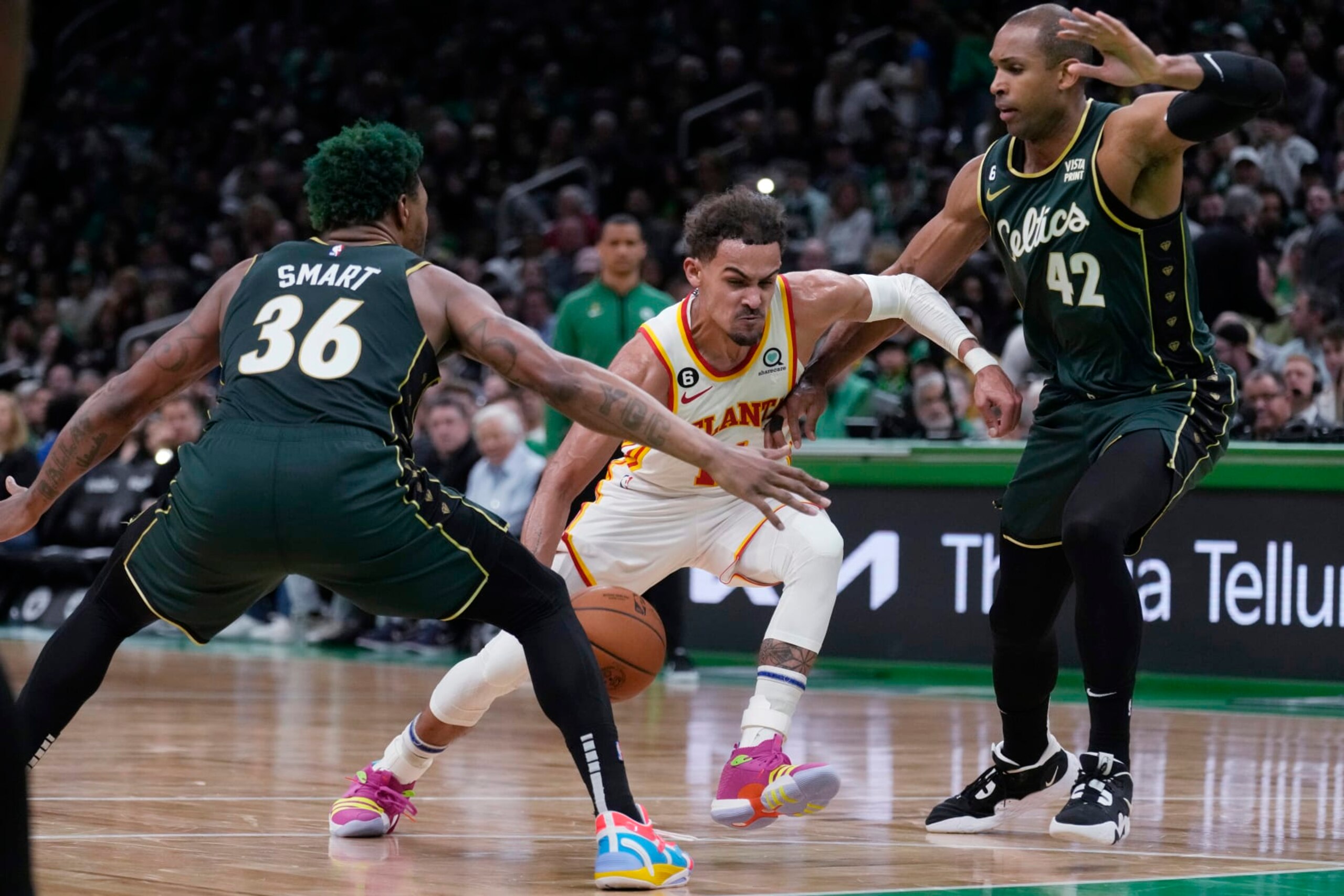 Atlanta Hawks guard Trae Young, center, drives to the basket against Boston Celtics guard Marcus Smart (36) and center Al Horford (42) during the first half of Game 5 in a first-round NBA basketball playoff series Tuesday, April 25, 2023, in Boston. (AP Photo/Charles Krupa)