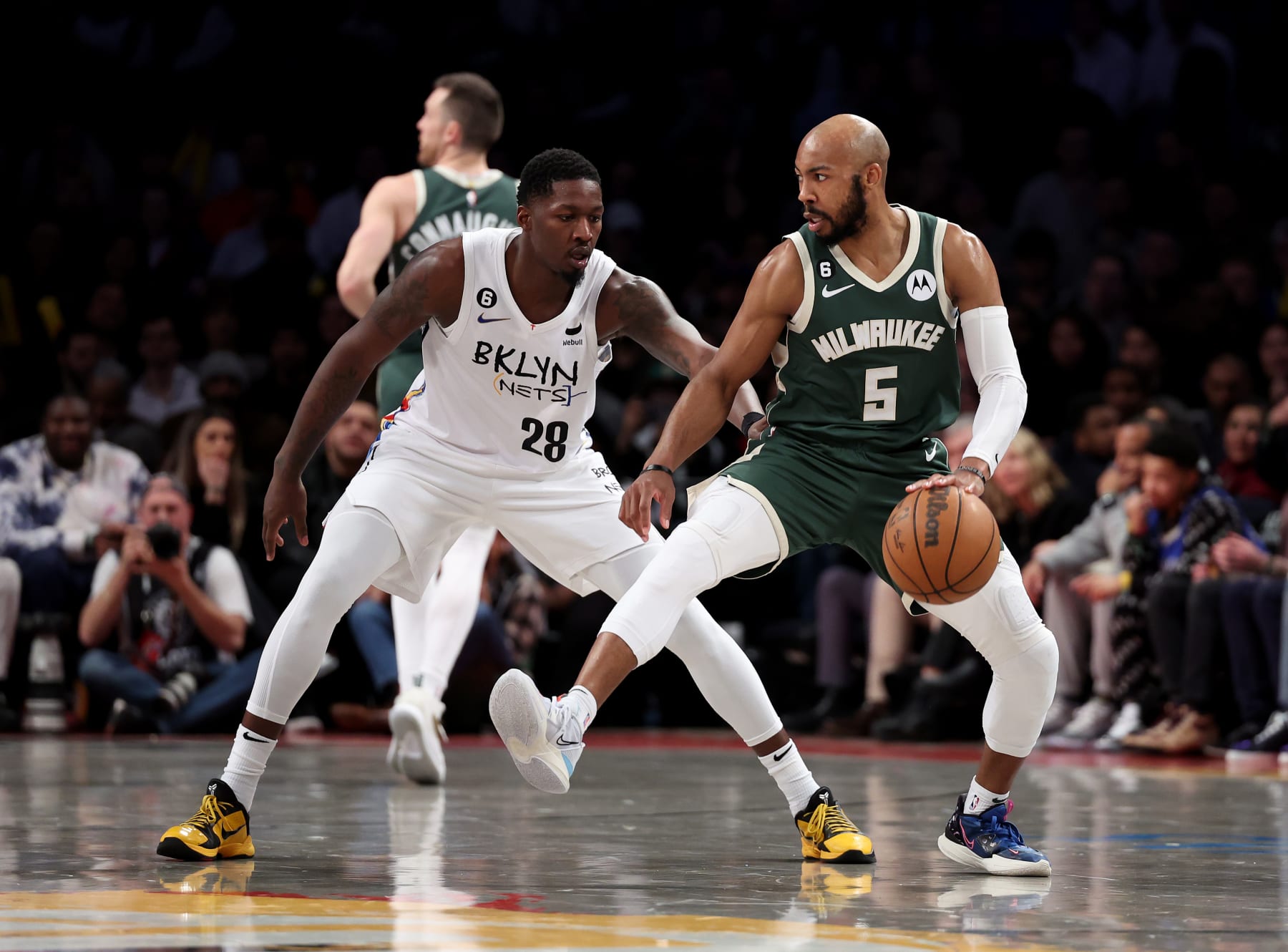 NEW YORK, NEW YORK - FEBRUARY 28:  Jevon Carter #5 of the Milwaukee Bucks in action against Dorian Finney-Smith #28 of the Brooklyn Nets during their game at Barclays Center on February 28, 2023 in New York City.  User expressly acknowledges and agrees that, by downloading and or using this photograph, User is consenting to the terms and conditions of the Getty Images License Agreement.   (Photo by Al Bello/Getty Images)