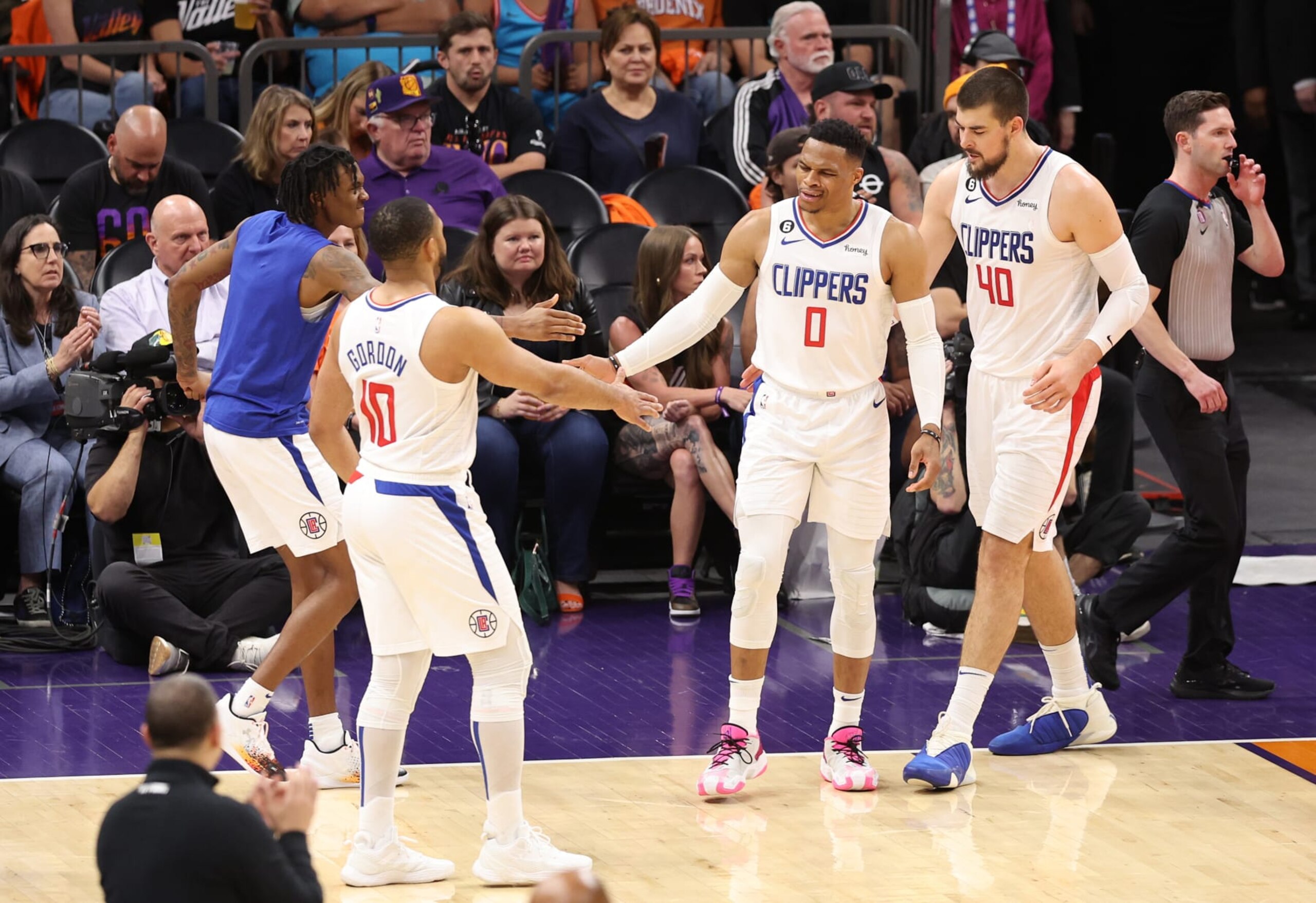 PHOENIX, ARIZONA - APRIL 25: Russell Westbrook #0 of the LA Clippers high fives Eric Gordon #10 during the third quarter against the Phoenix Suns in game five of the Western Conference First Round Playoffs at Footprint Center on April 25, 2023 in Phoenix, Arizona. NOTE TO USER: User expressly acknowledges and agrees that, by downloading and or using this photograph, User is consenting to the terms and conditions of the Getty Images License Agreement. (Photo by Christian Petersen/Getty Images)