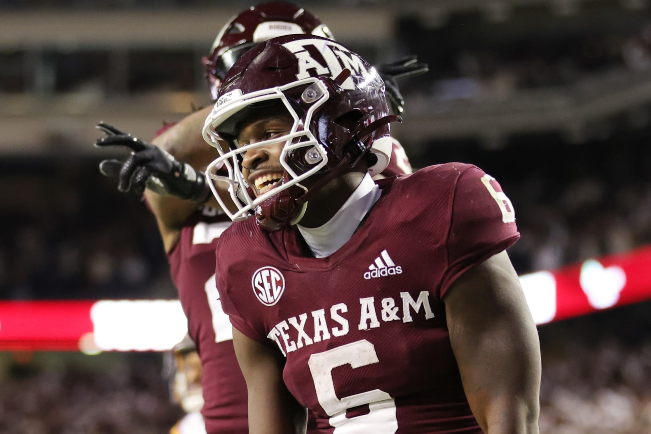COLLEGE STATION, TEXAS - NOVEMBER 26: Devon Achane #6 celebrates his rushing touchdown with Devin Price #3 of the Texas A&M Aggies against the LSU Tigers during the second half at Kyle Field on November 26, 2022 in College Station, Texas. (Photo by Carmen Mandato/Getty Images)