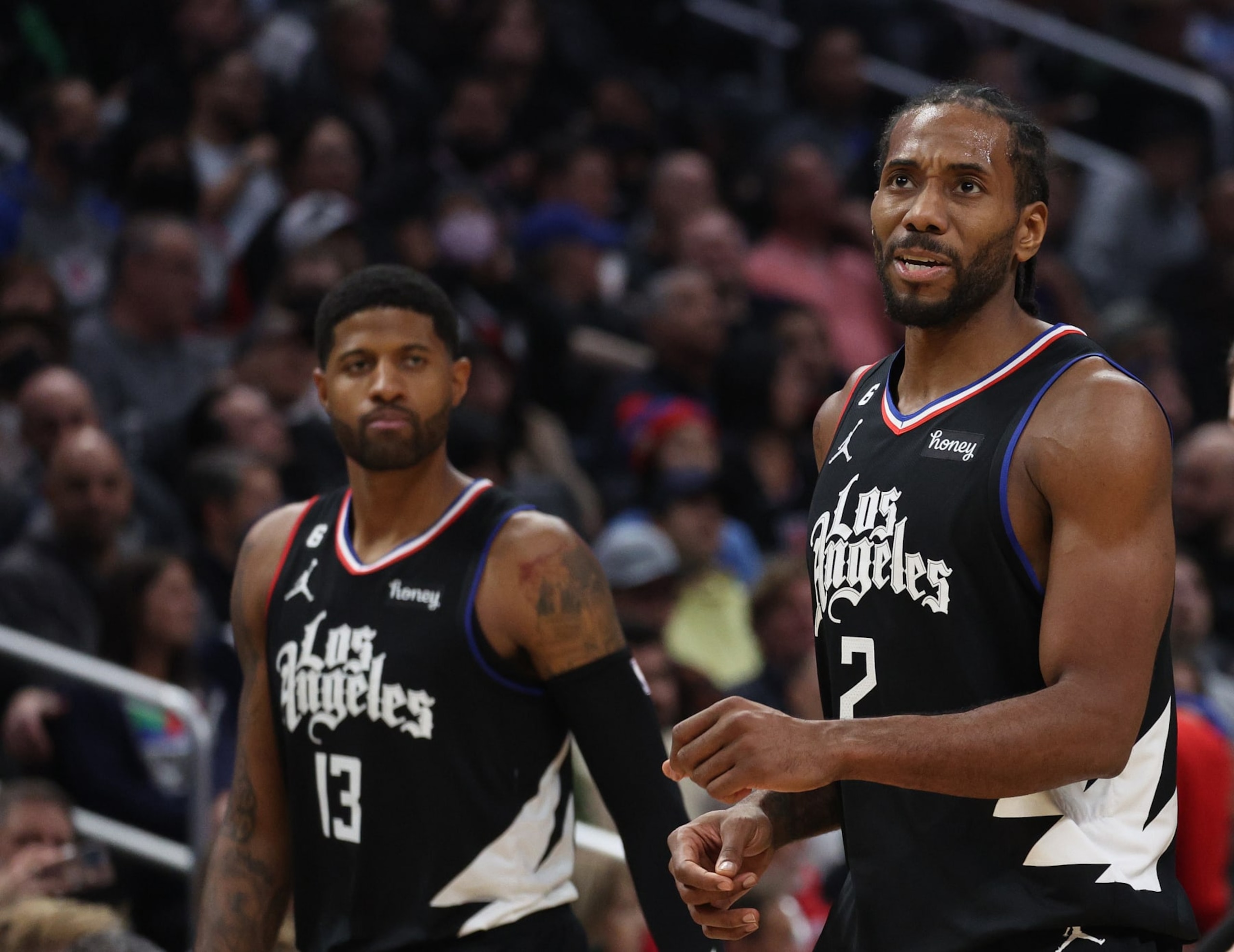 LOS ANGELES, CALIFORNIA - DECEMBER 14: Kawhi Leonard #2 of the LA Clippers reacts after a Minnesota Timberwolves foul in front of Paul George #13 during a 99-88 win at Crypto.com Arena on December 14, 2022 in Los Angeles, California. (Photo by Harry How/Getty Images) NOTE TO USER: User expressly acknowledges and agrees that, by downloading and/or using this photograph, User is consenting to the terms and conditions of the Getty Images License Agreement. Mandatory Copyright Notice: Copyright 2022 NBAE.