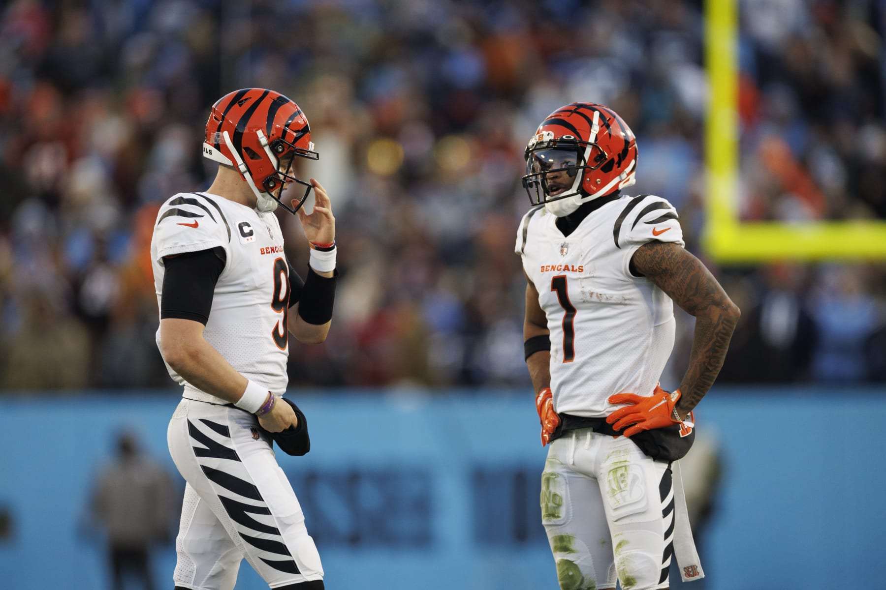 Cincinnati Bengals quarterback Joe Burrow (9) and wide receiver Ja'Marr Chase (1) walk on the field during the second quarter of an NFL divisional playoff football game against the Tennessee Titans, Saturday, Jan. 22, 2022, in Nashville, Tenn. (AP Photo/Brett Carlsen)