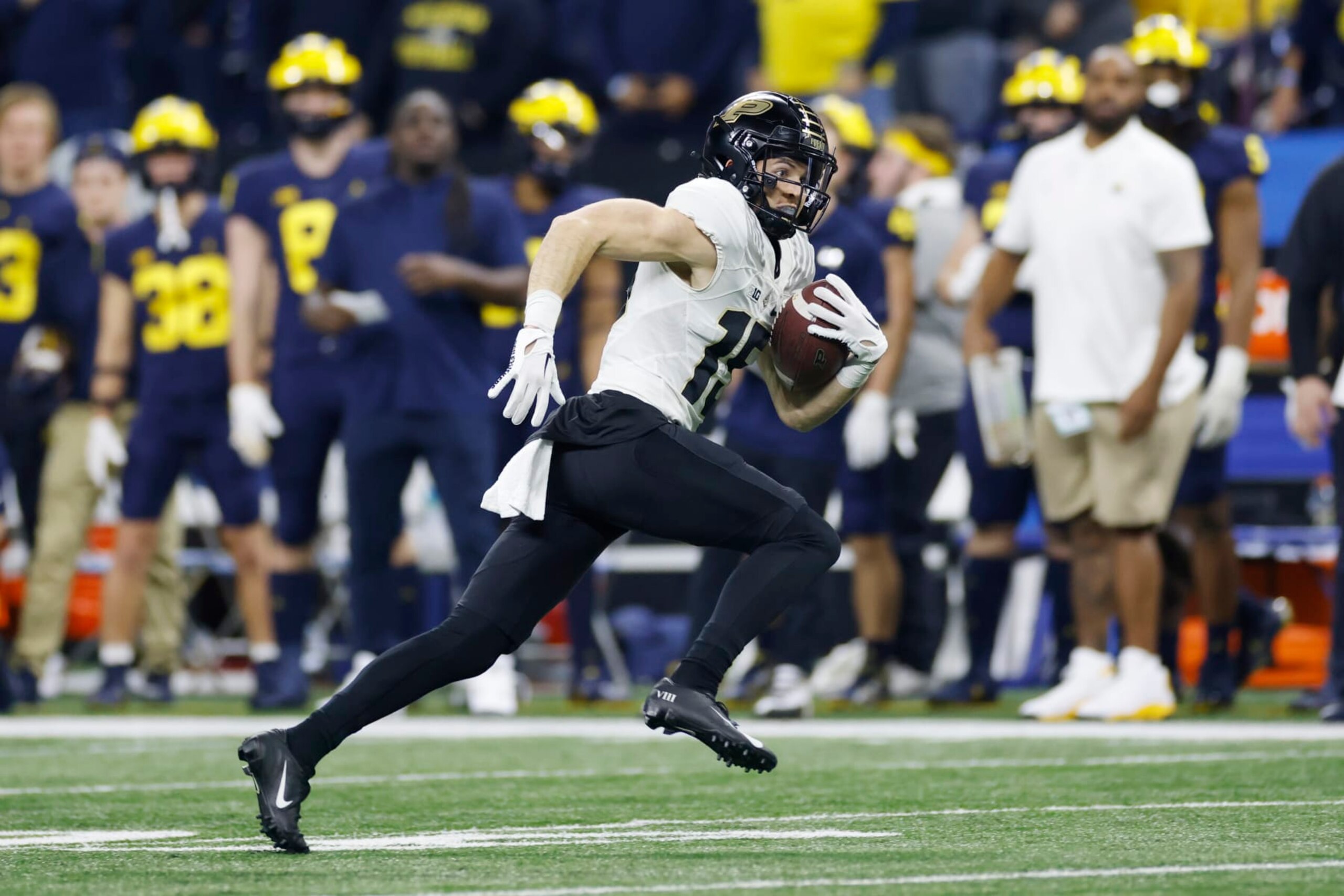 INDIANAPOLIS, IN - DECEMBER 03: Purdue Boilermakers wide receiver Charlie Jones (15) runs with the ball after catching a pass during the Big 10 Championship college football game against the Michigan Wolverines on December 3, 2022 at Lucas Oil Stadium in Indianapolis, Indiana. (Photo by Joe Robbins/Icon Sportswire via Getty Images)