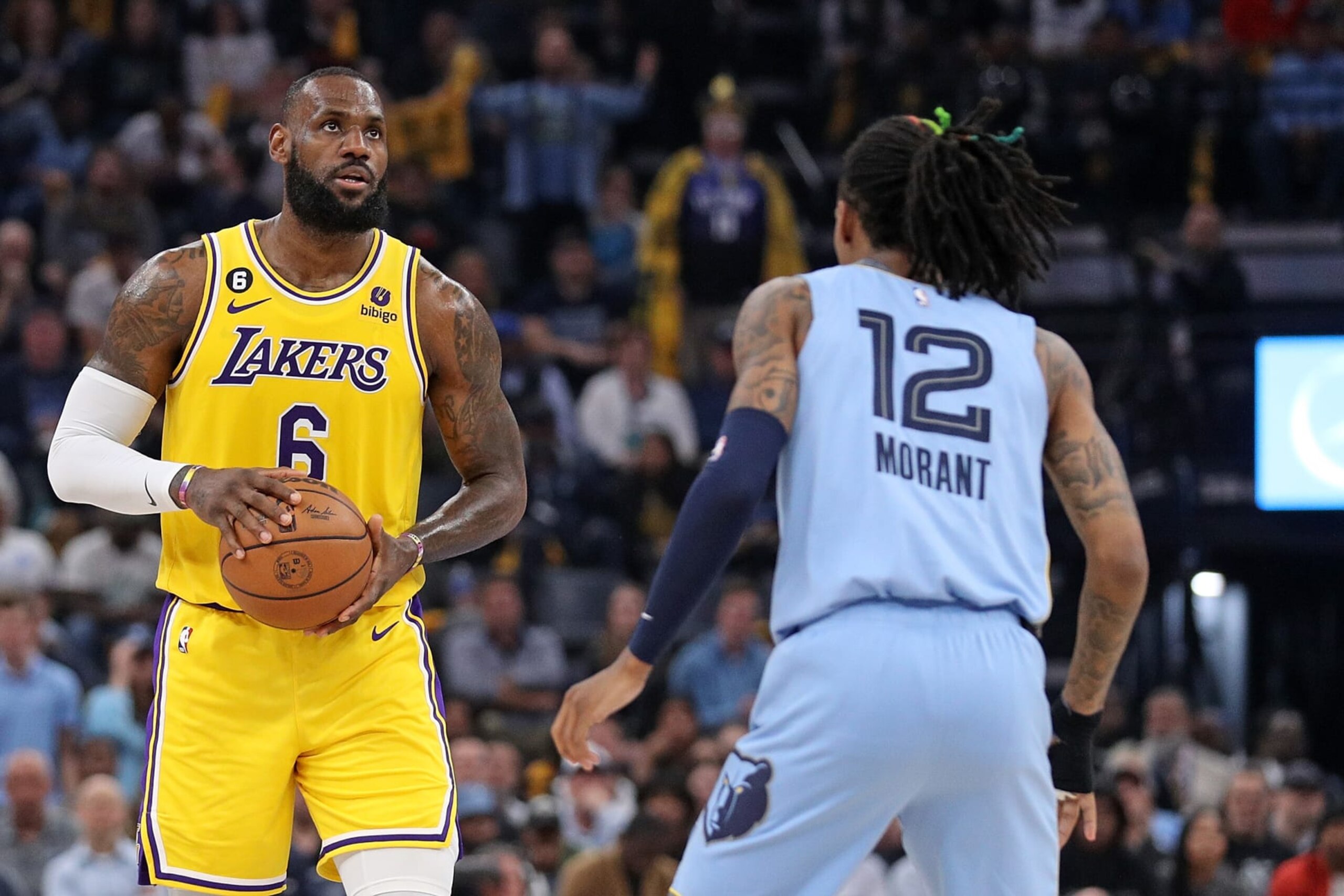 MEMPHIS, TENNESSEE - APRIL 26: LeBron James #6 of the Los Angeles Lakers handles the ball against Ja Morant #12 of the Memphis Grizzlies during the first half of Game Five of the Western Conference First Round Playoffs at FedExForum on April 26, 2023 in Memphis, Tennessee. NOTE TO USER: User expressly acknowledges and agrees that, by downloading and or using this photograph, User is consenting to the terms and conditions of the Getty Images License Agreement. (Photo by Justin Ford/Getty Images)