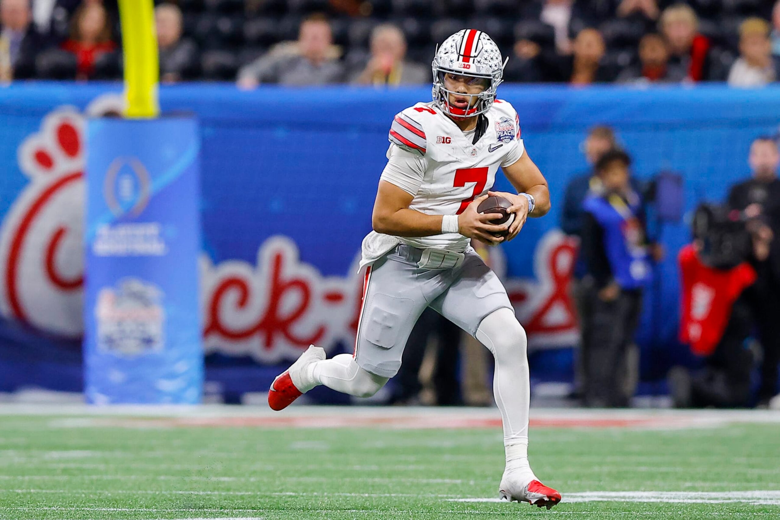 ATLANTA, GEORGIA - DECEMBER 31: C.J. Stroud #7 of the Ohio State Buckeyes rushes during the third quarter against the Georgia Bulldogs in the Chick-fil-A Peach Bowl at Mercedes-Benz Stadium on December 31, 2022 in Atlanta, Georgia. (Photo by Todd Kirkland/Getty Images)