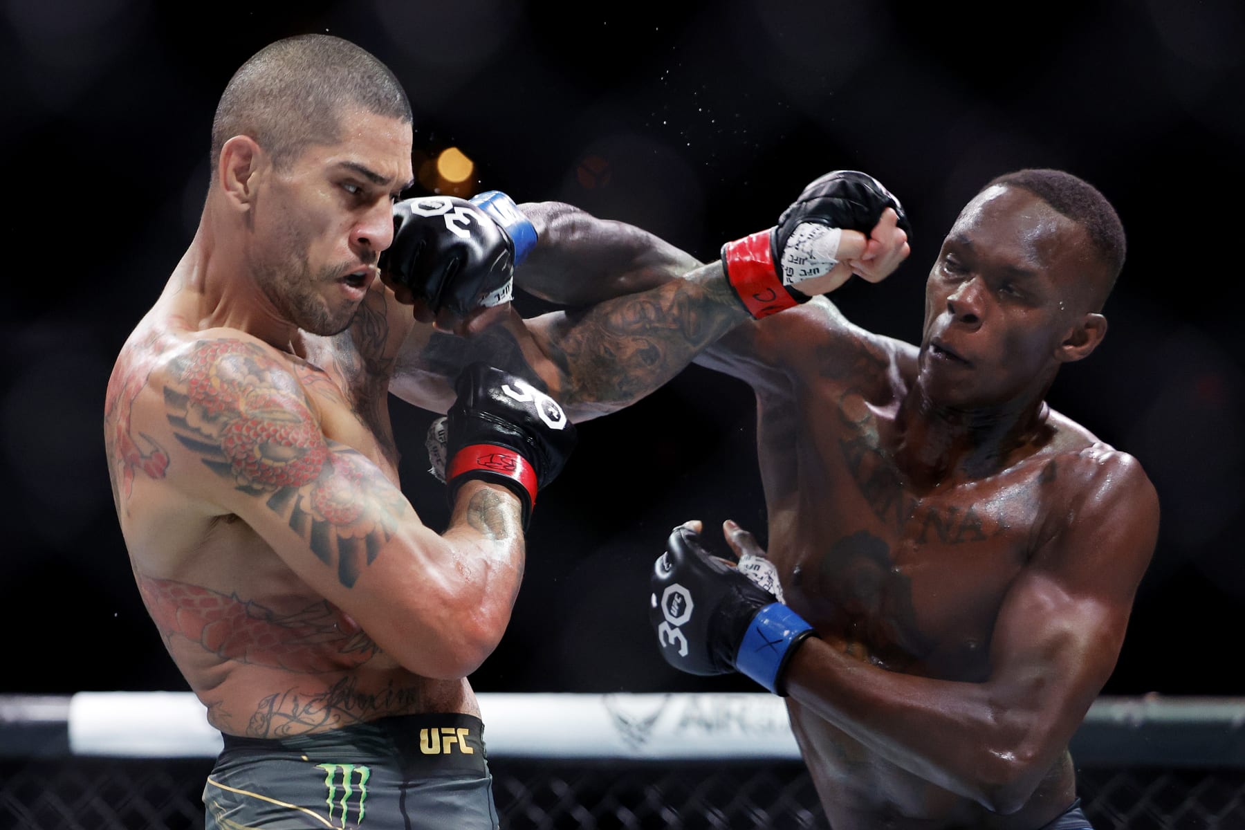 MIAMI, FLORIDA - APRIL 08: Israel Adesanya (R) of Nigeria punches Alex Pereira of Brazil in their middleweight title bout during UFC 287 at Kaseya Center on April 08, 2023 in Miami, Florida. (Photo by Carmen Mandato/Getty Images)