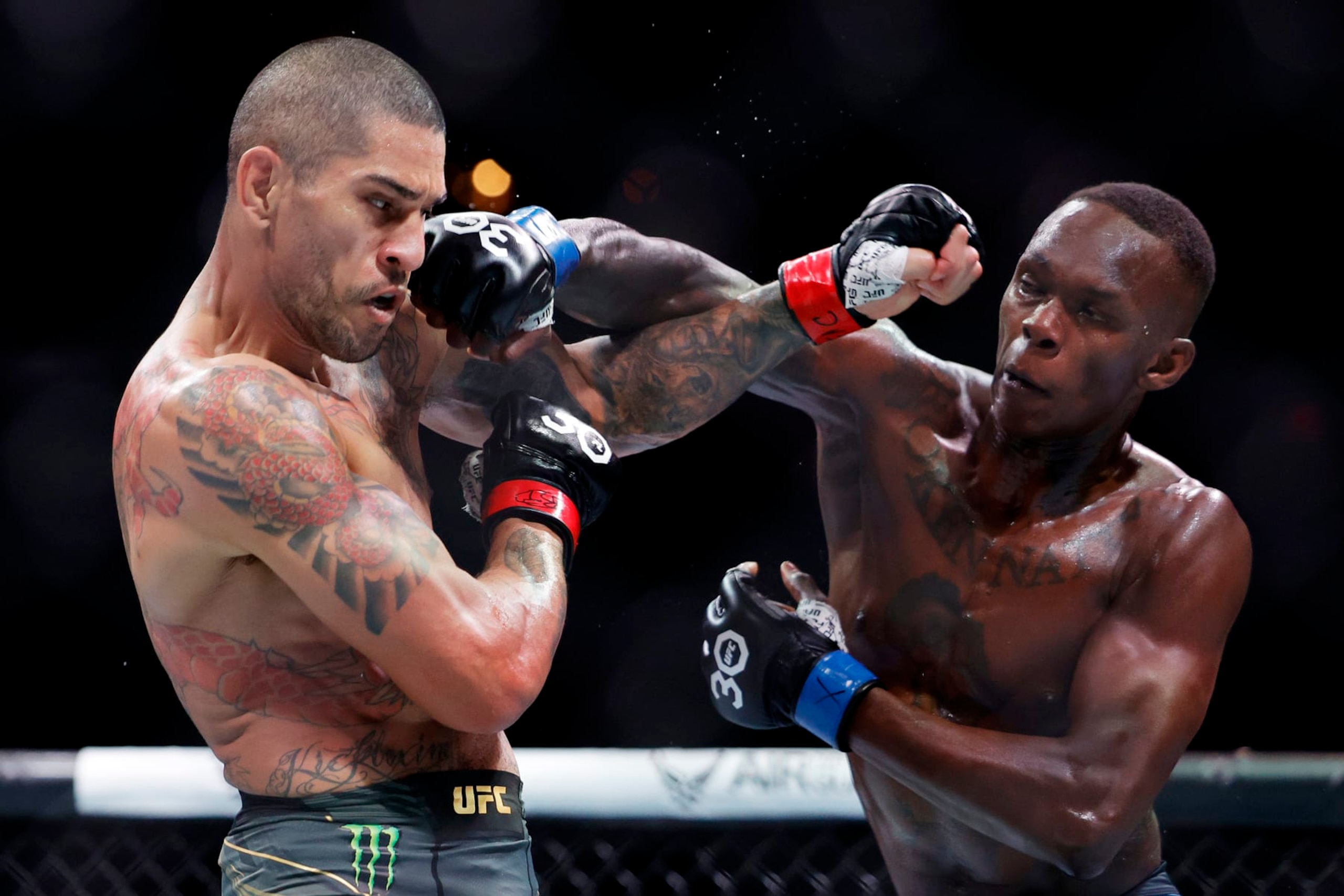 MIAMI, FLORIDA - APRIL 08: Israel Adesanya (R) of Nigeria punches Alex Pereira of Brazil in their middleweight title bout during UFC 287 at Kaseya Center on April 08, 2023 in Miami, Florida. (Photo by Carmen Mandato/Getty Images)