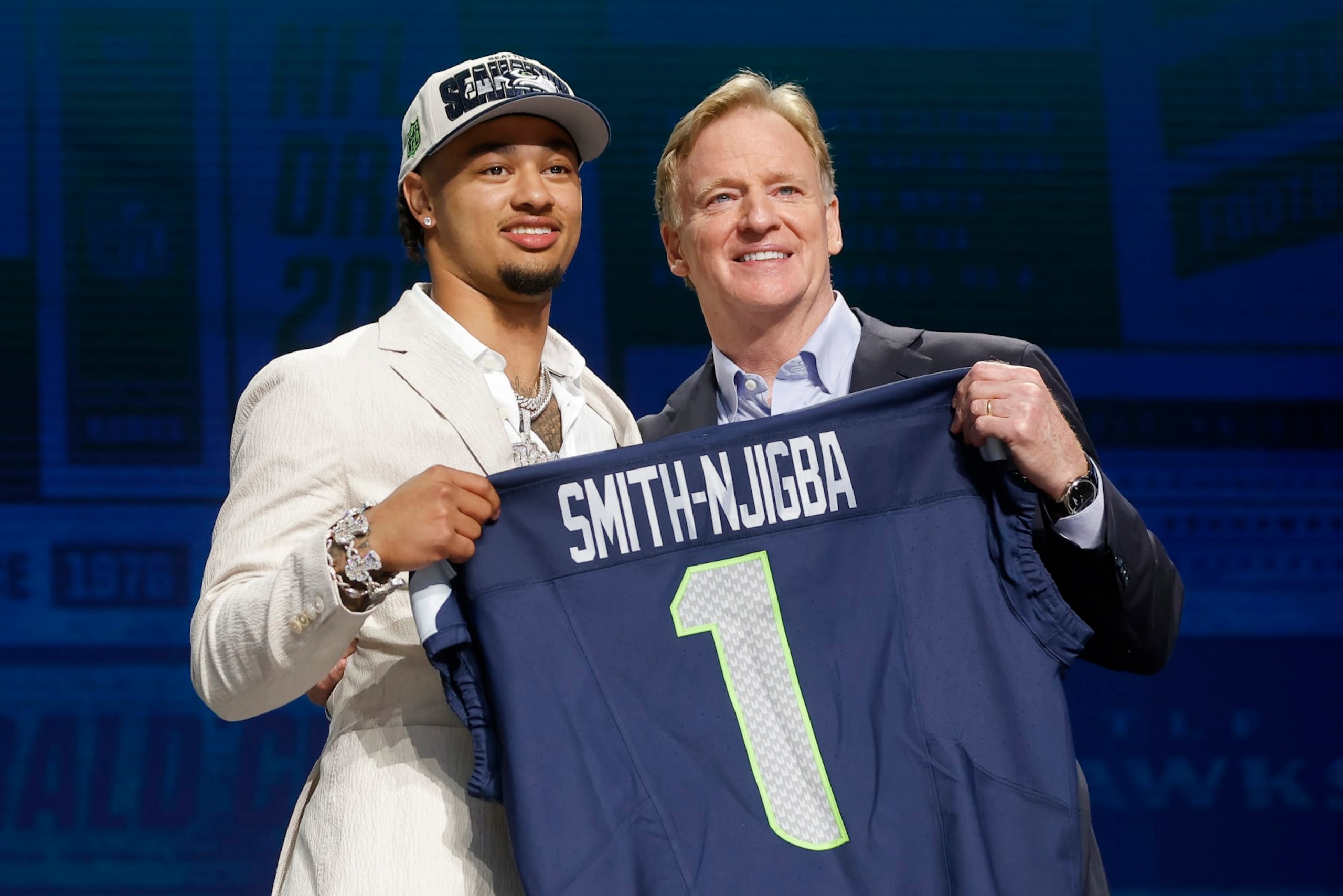 KANSAS CITY, MISSOURI - APRIL 27: (L-R) Jaxon Smith-Njigba poses with NFL Commissioner Roger Goodell after being selected 20th overall by the Seattle Seahawks during the first round of the 2023 NFL Draft at Union Station on April 27, 2023 in Kansas City, Missouri. (Photo by David Eulitt/Getty Images)